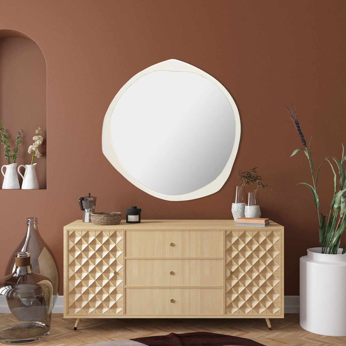 A softly contoured ivory mirror adds a luminous accent above a wood console || MRR3070A || front_room