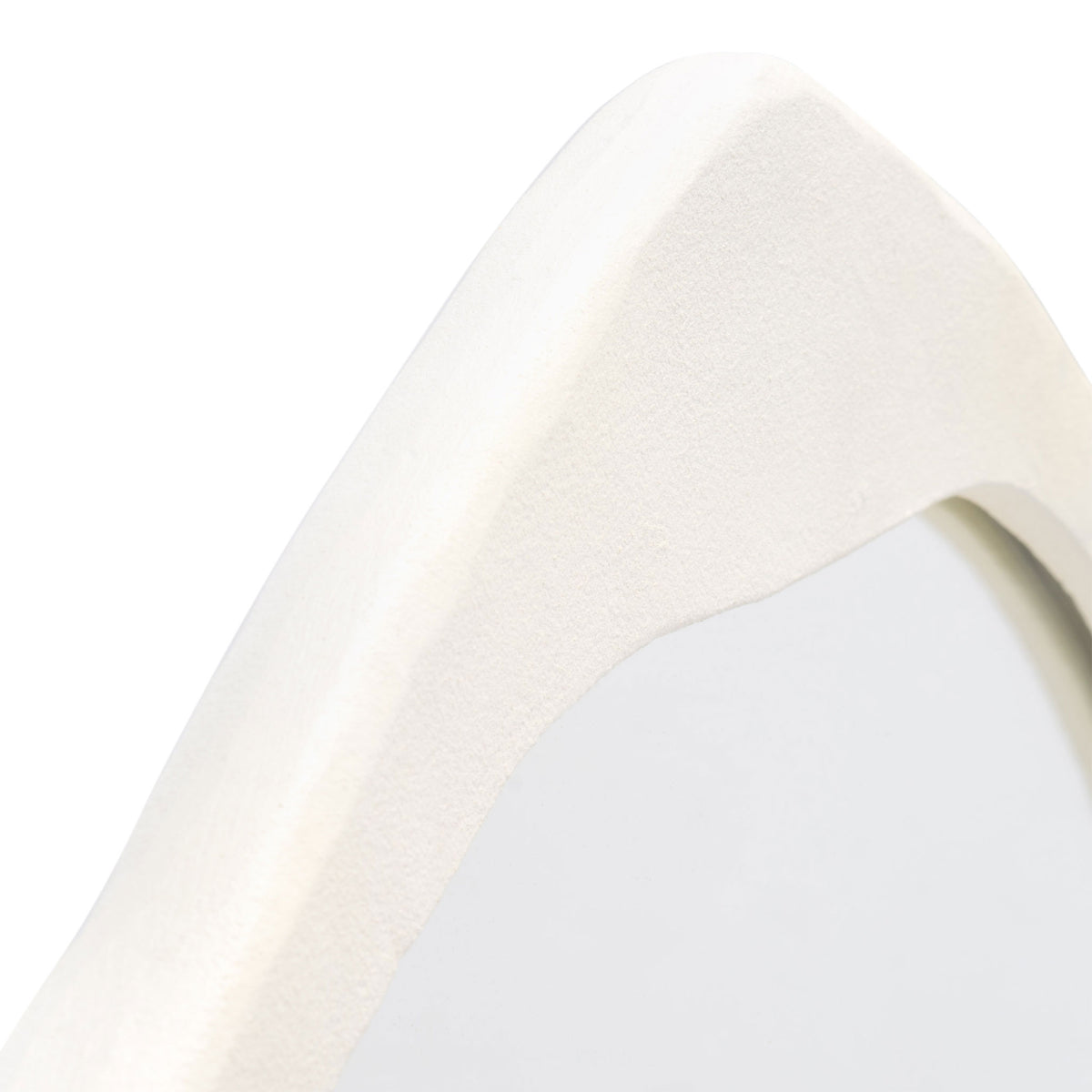 Subtly textured ivory frame curves around the reflective glass