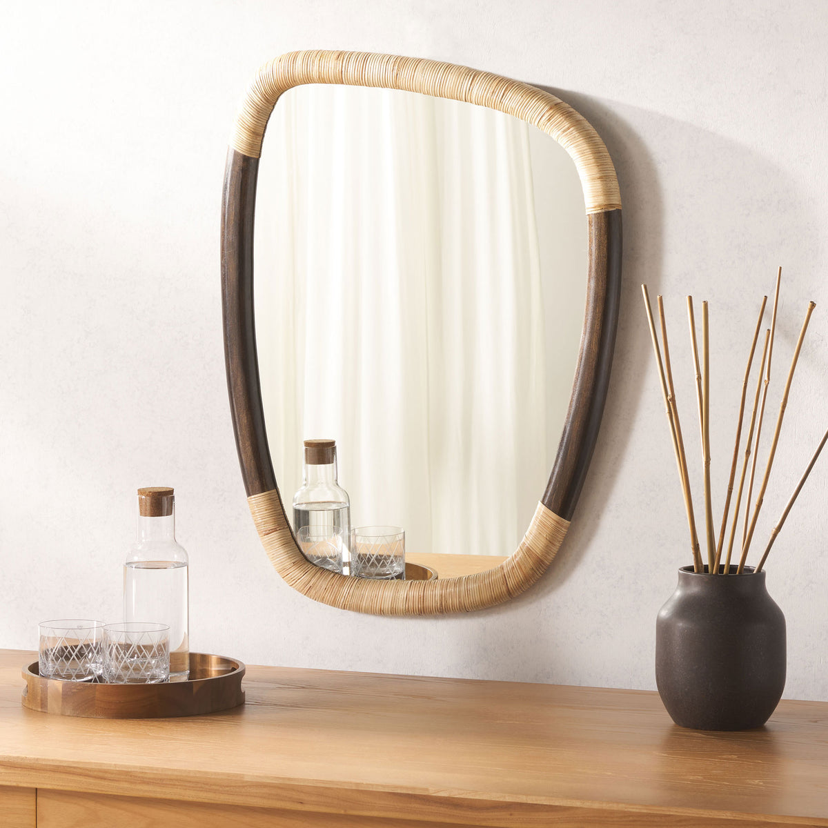 Cane-wrapped mirror adds natural texture above a warm wood console || MRR4002A || front_room