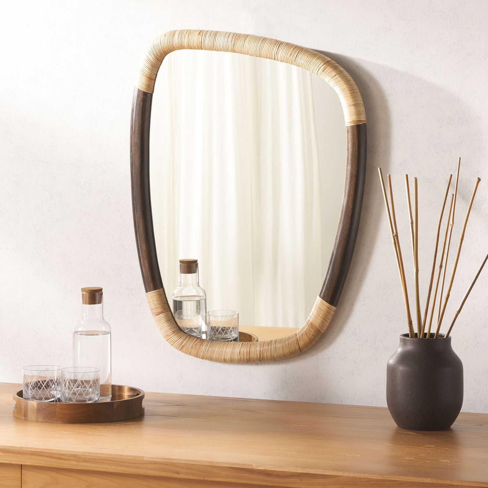 Cane-wrapped mirror adds natural texture above a warm wood console || MRR4002A || front_room