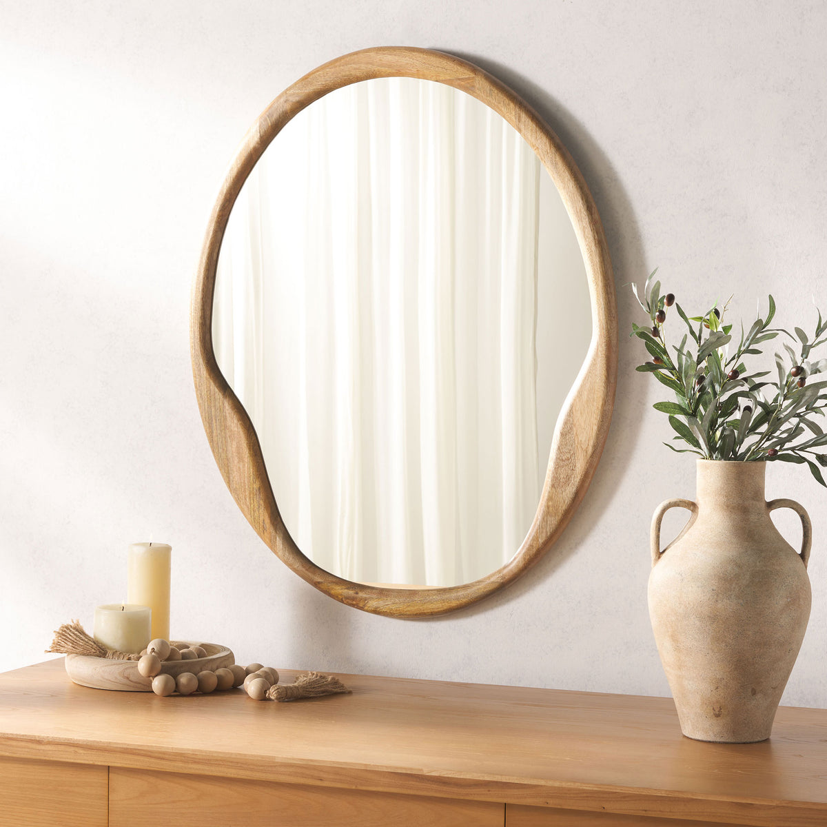 Organic wood-framed mirror adds warmth and soft curves above a wooden console || MRR4003A || front_room