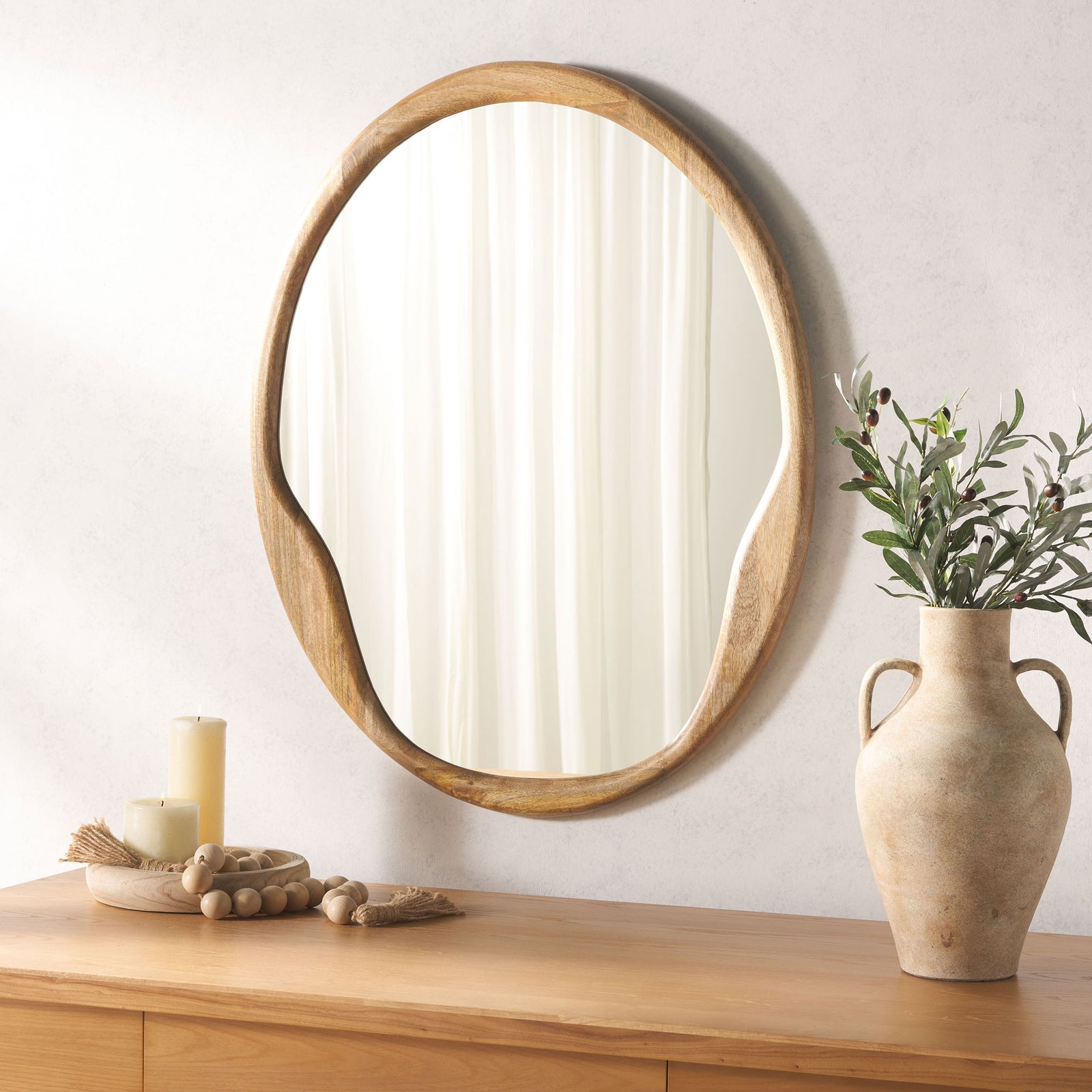 Organic wood-framed mirror adds warmth and soft curves above a wooden console || MRR4003A || front_room