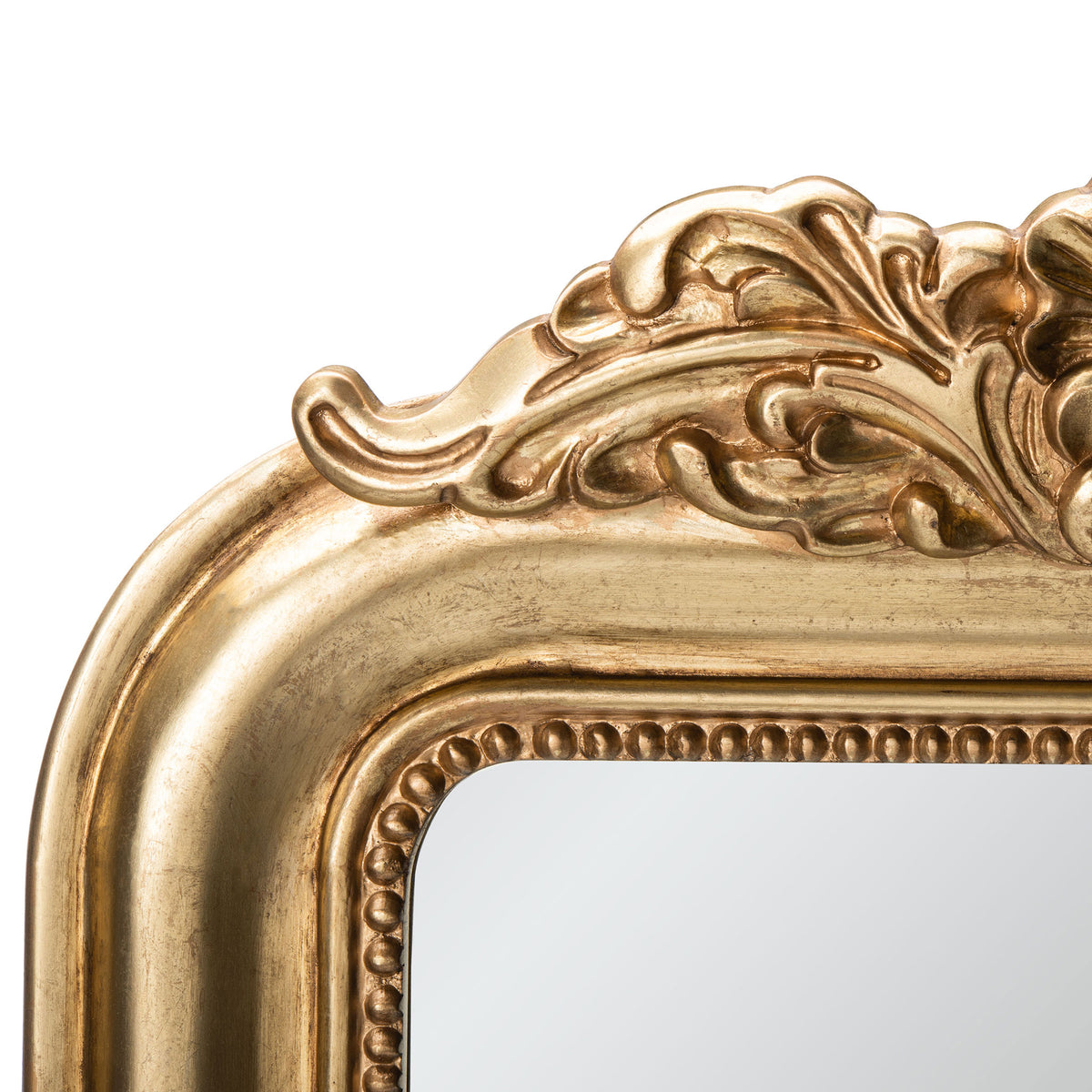 Sculpted leaves and scrollwork frame the antique gold mirror's beaded inner edge || MRR5000A || detail_studio