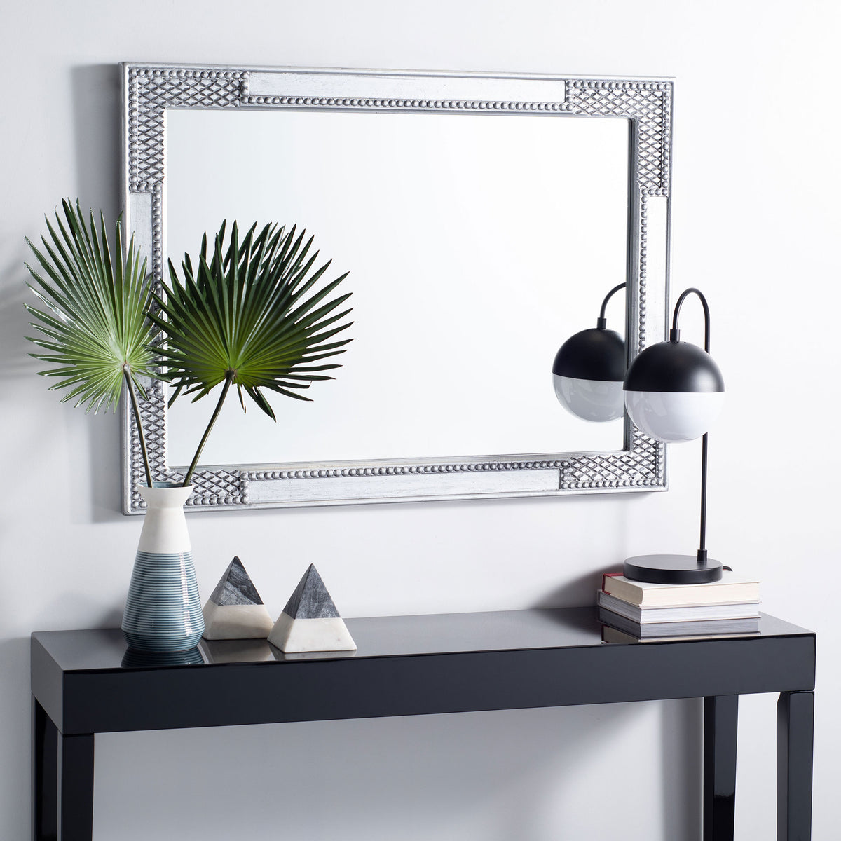 Antique silver mirror hangs horizontally above a console, adding ornate texture to the room || MRR5003B || front_room