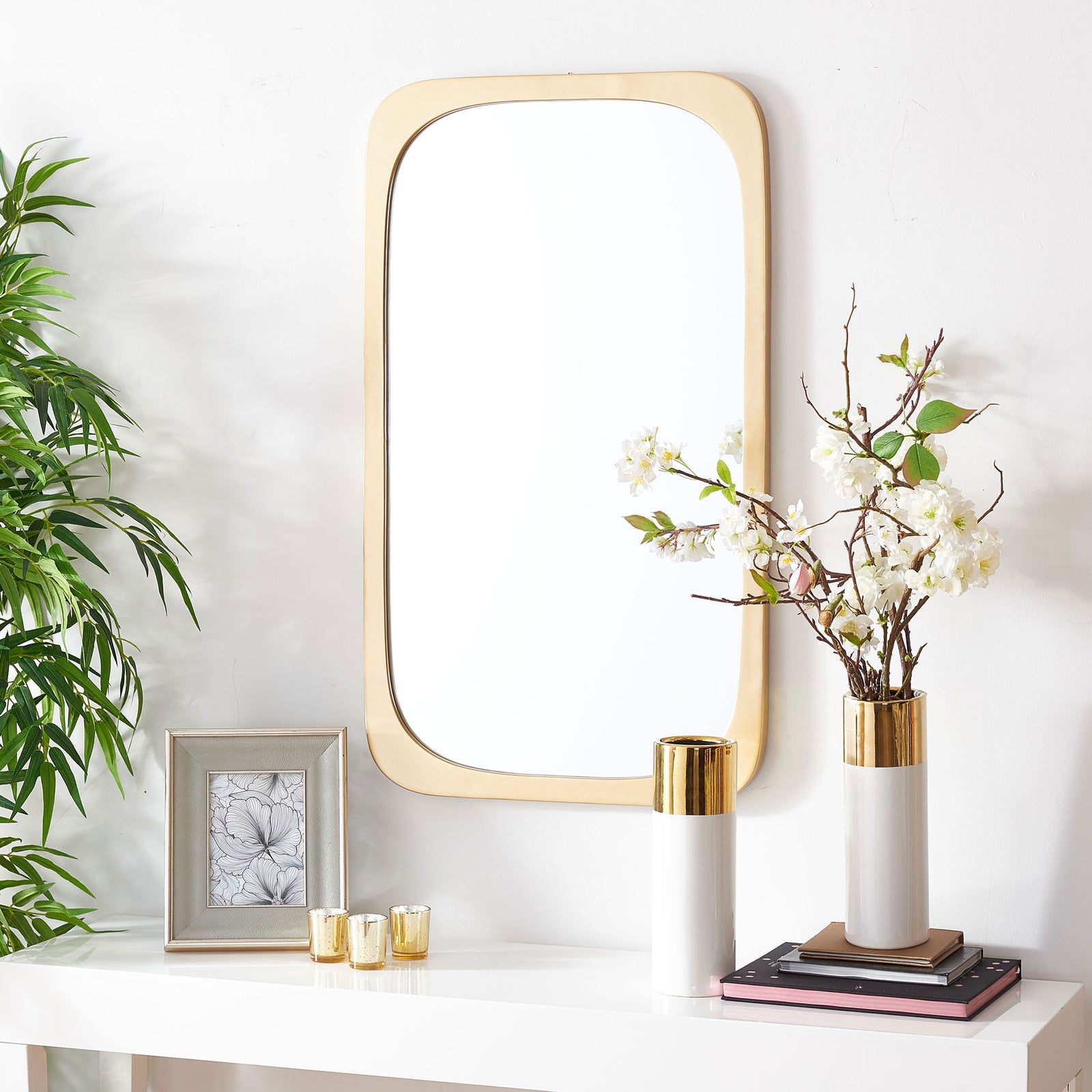 A tall gold-framed mirror adds warmth above a white console || MRR8001A || front_room