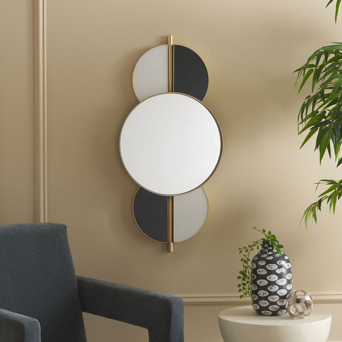 A round wall mirror with black and white accents brings graphic contrast to a softly furnished living room || MRR8003A || front_room