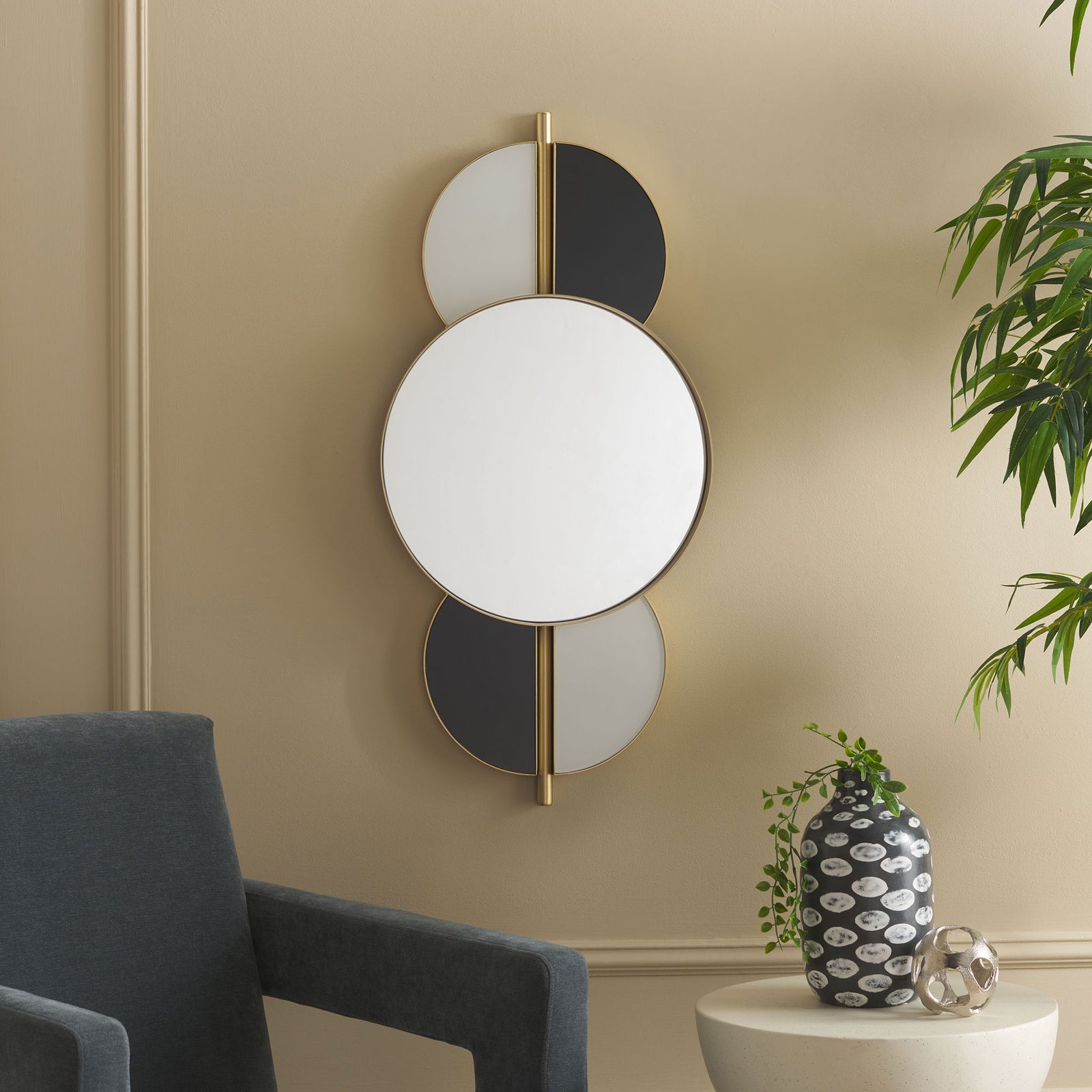 A round wall mirror with black and white accents brings graphic contrast to a softly furnished living room || MRR8003A || front_room