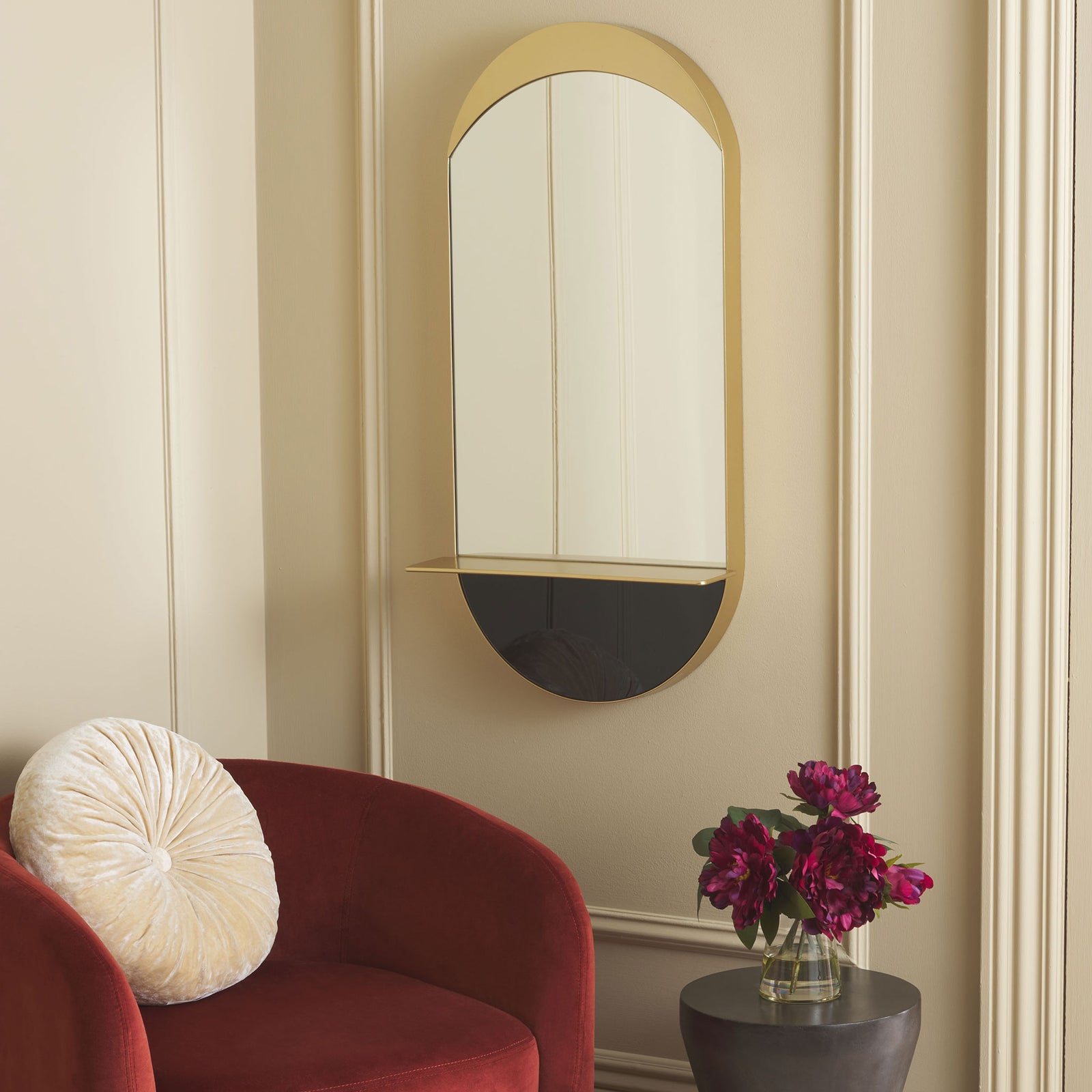 A sculptural gold mirror with a slim shelf and dark lower accent brings warmth to the wall. || MRR8010A || front_angle_room