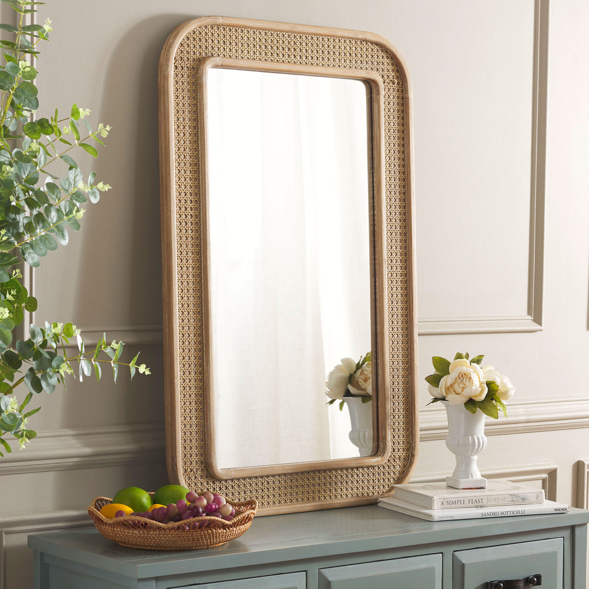 Warm wood and open cane lattice bring inviting texture to this wall-mounted mirror || MRR9000A || front_angle_room