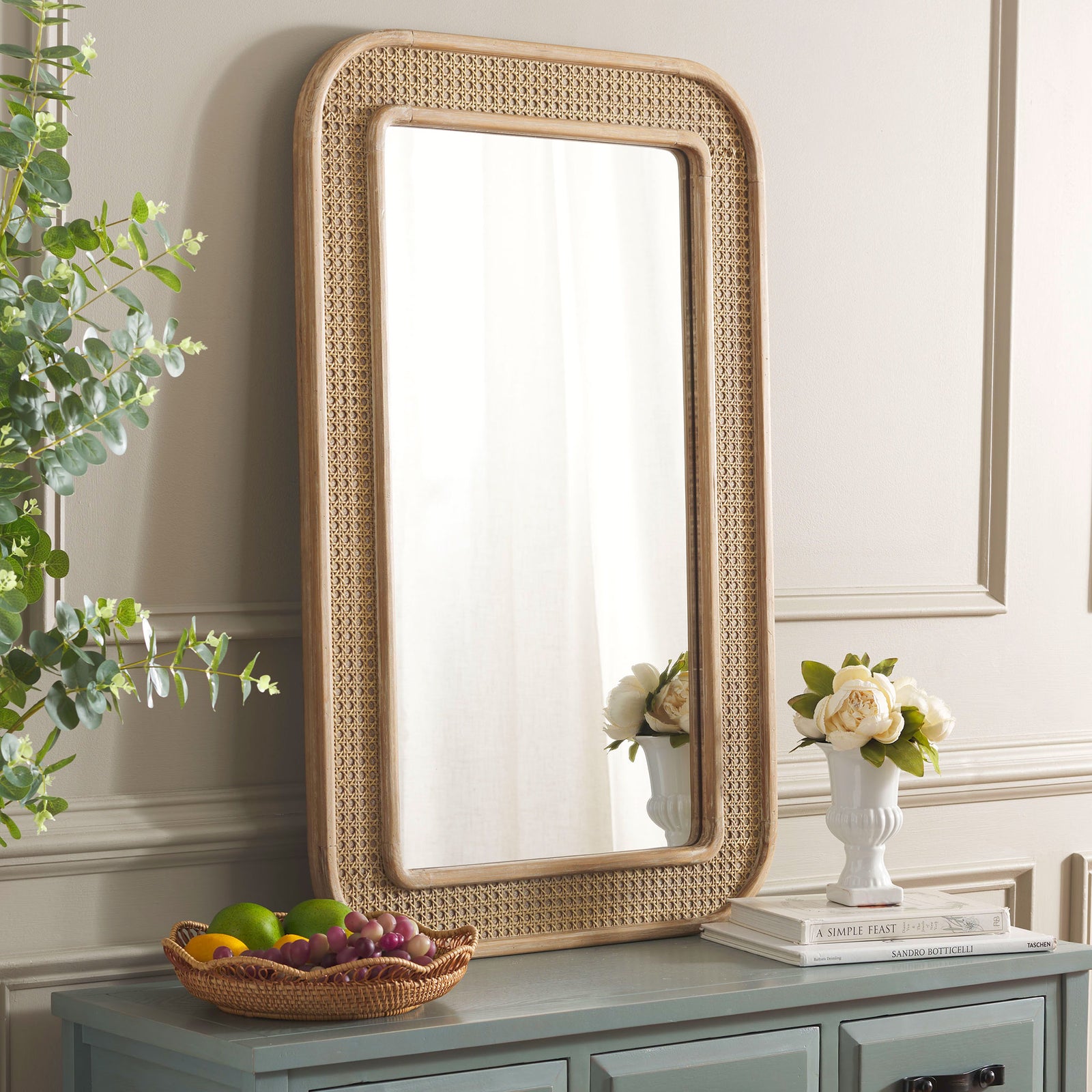 Warm wood and open cane lattice bring inviting texture to this wall-mounted mirror || MRR9000A || front_angle_room