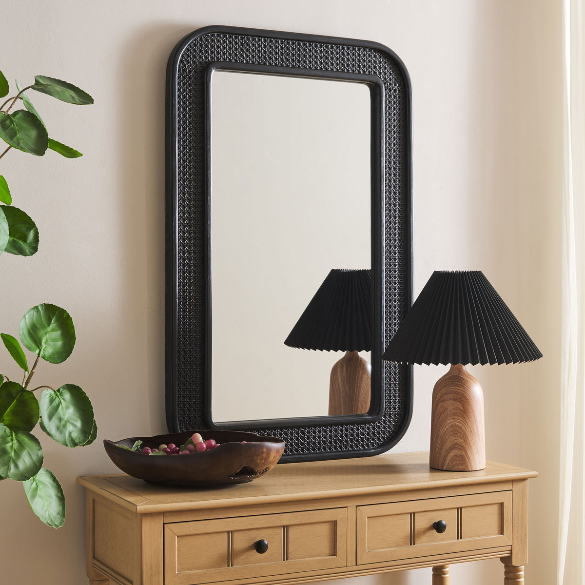 A black mirror with a textured lattice frame adds contrast above a wood console || MRR9000B || front_angle_room