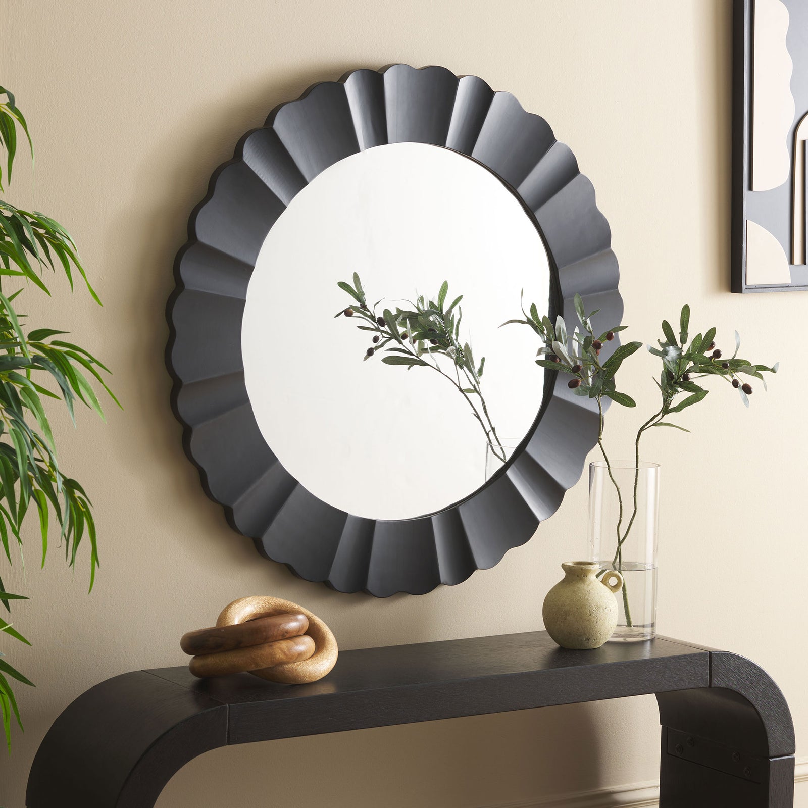 The black scalloped mirror lends a sculptural focal point above a console. || MRR9004B || front_room
