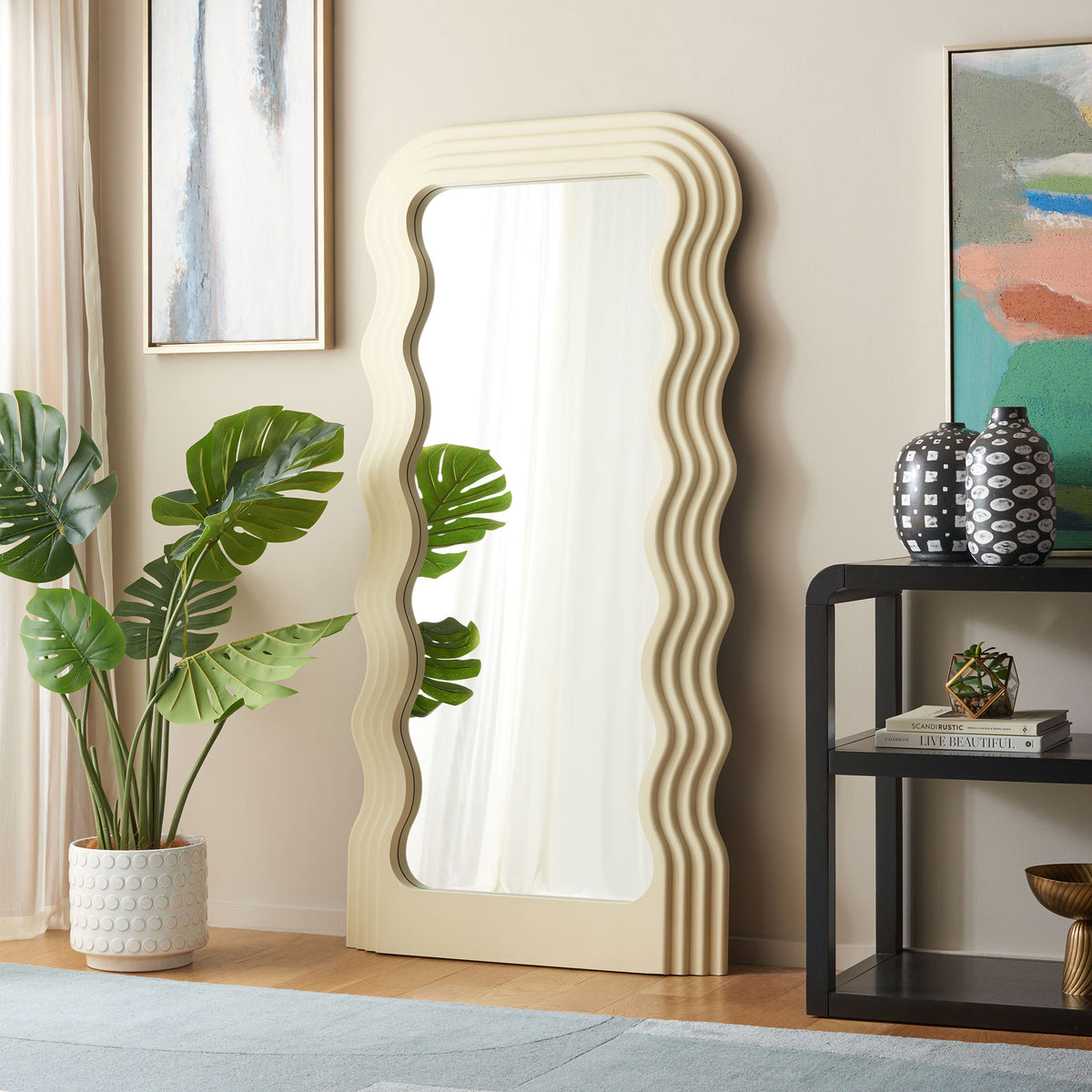 Sculpted white frame brightens a living space with flowing lines and a full-length reflection || MRR9006B || front_angle_room