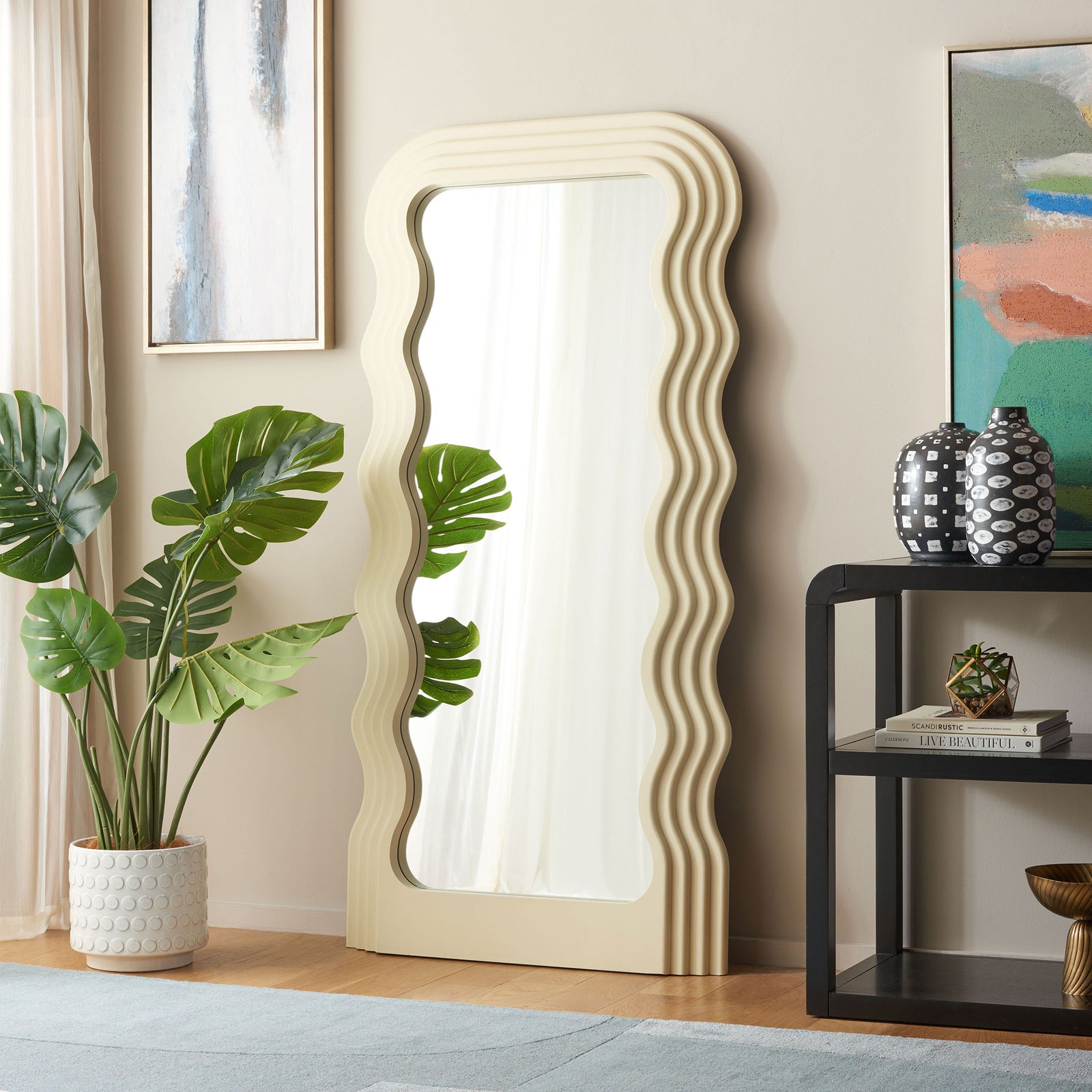 Sculpted white frame brightens a living space with flowing lines and a full-length reflection || MRR9006B || front_angle_room