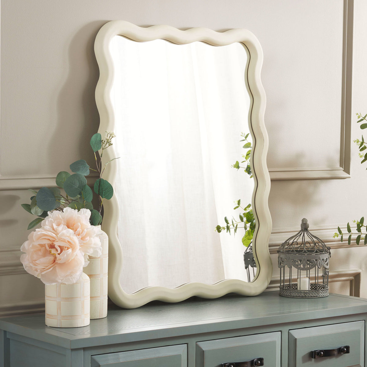 Wavy white mirror brightens the space above a blue-gray console || MRR9007A || front_angle_room