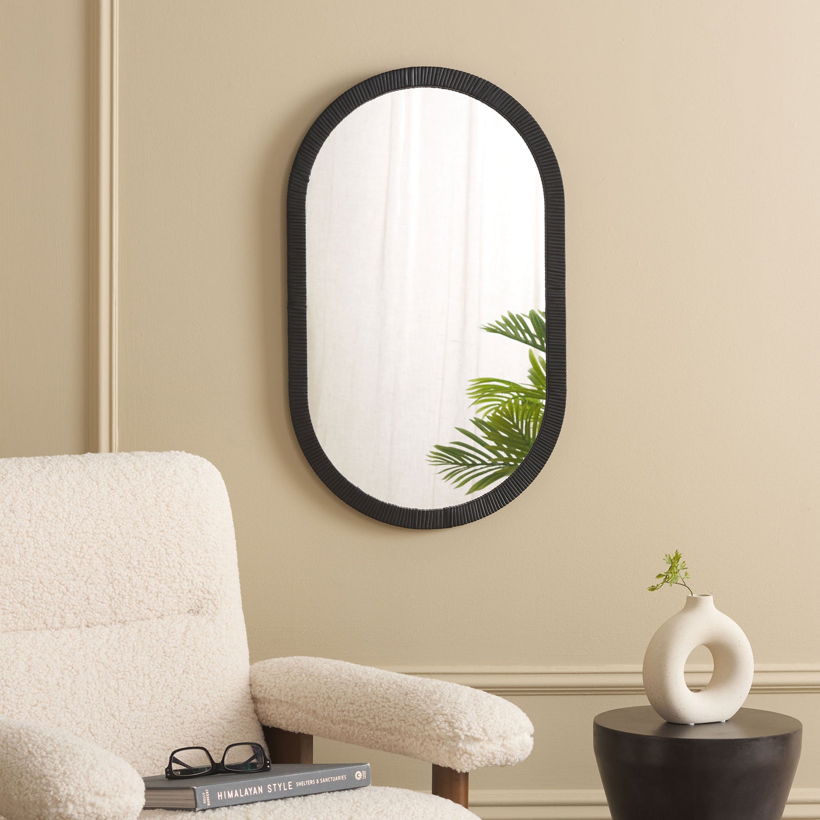Wall-mounted black oval mirror brings texture and contrast to a warm, neutral interior || MRR9008A || front_room