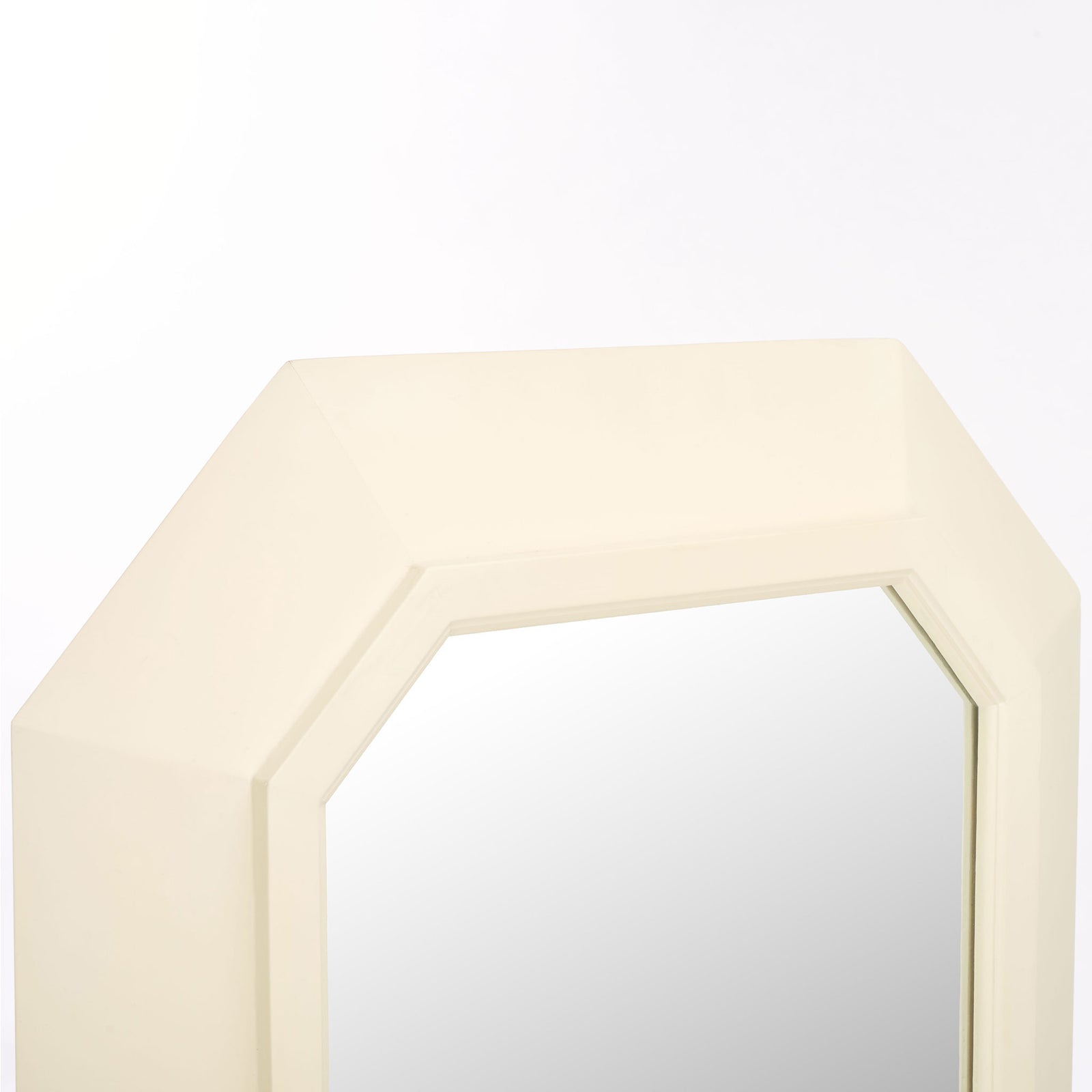 A wide white wood frame with beveled edges lends depth and definition to the mirror. || MRR9009A || detail_studio