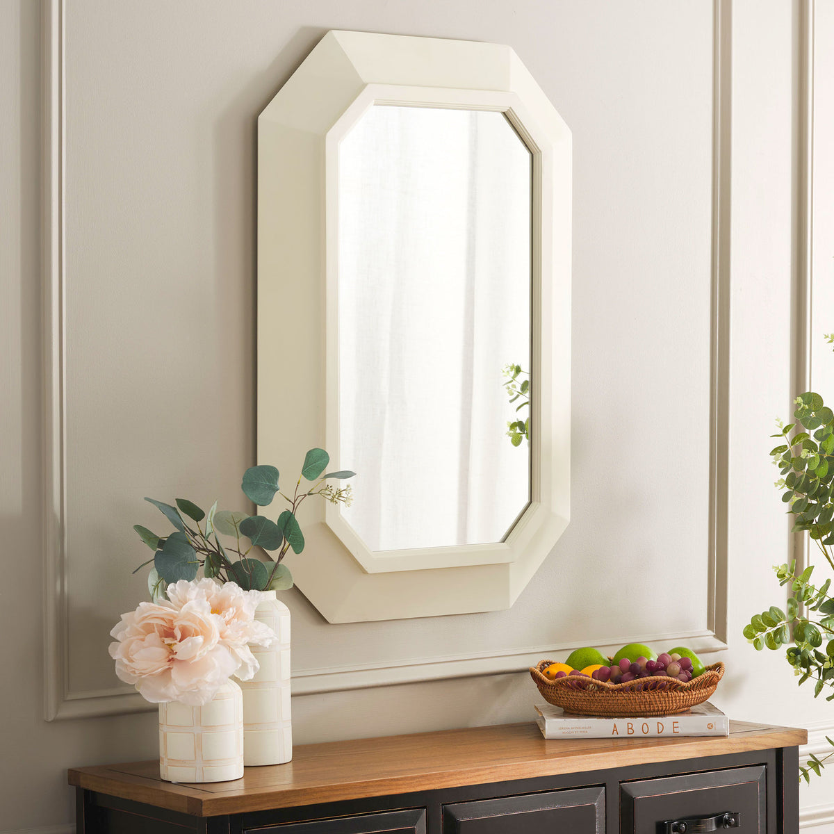 A white octagonal mirror brings soft geometric style above a wood-topped cabinet. || MRR9009A || front_angle_room