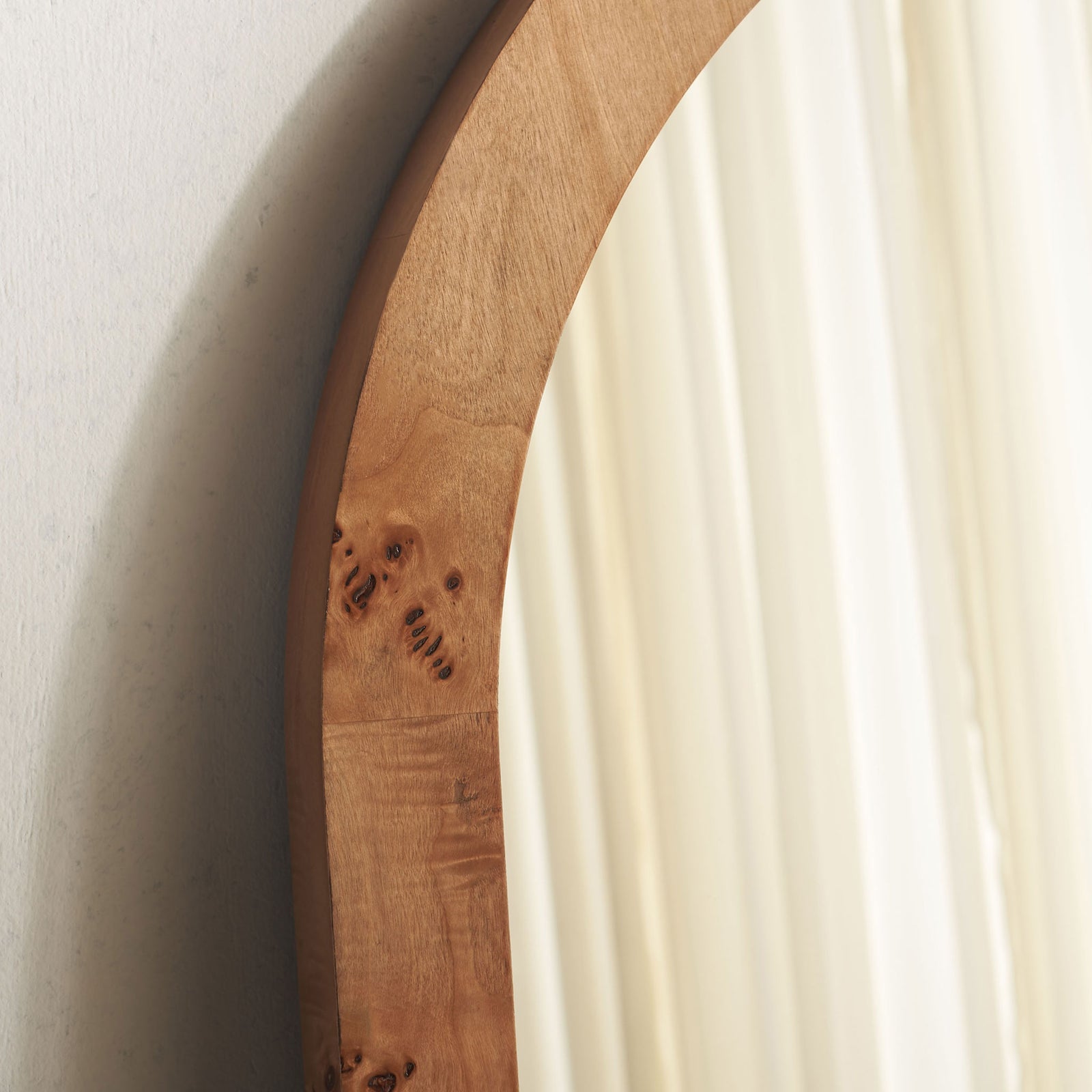 Rich wood grain and natural knots bring character to the curved mirror frame || MRR9013A || detail_room