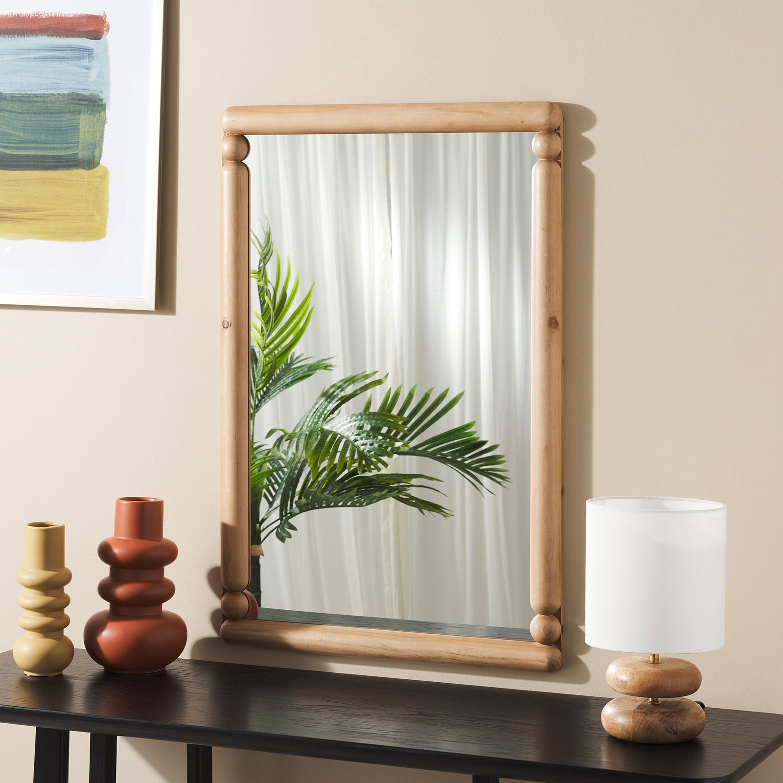 Warm wood-framed mirror with bead accents brings an inviting touch to a neutral interior || MRR9019A || front_room