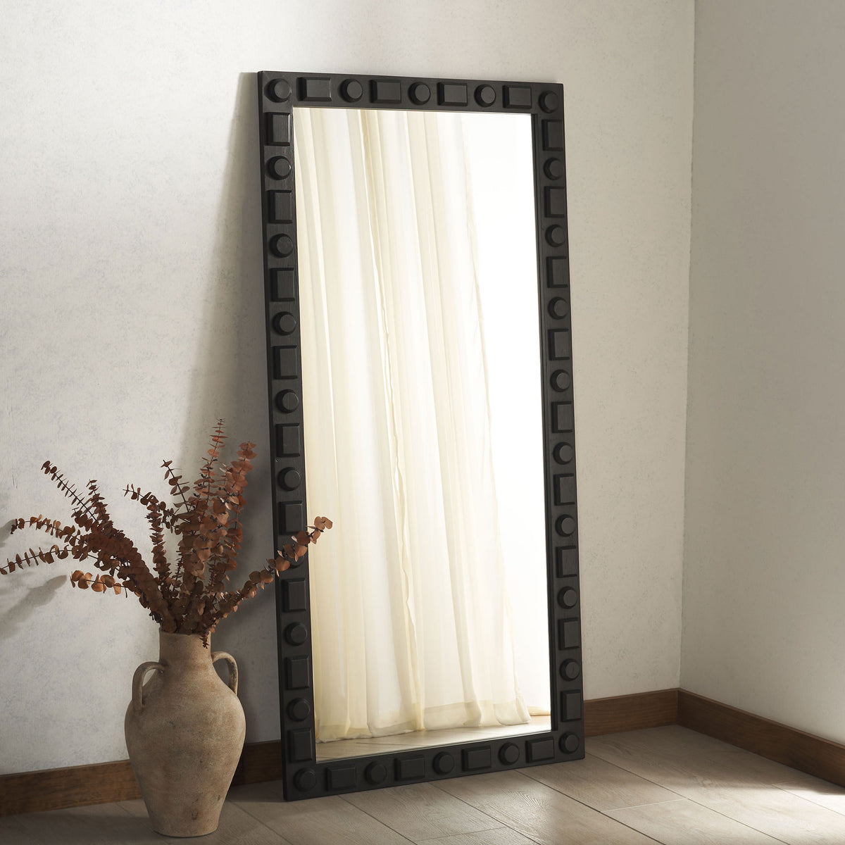 Tall mirror with a bold black geometric frame brings graphic contrast to a neutral space || MRR9022A || front_angle_room