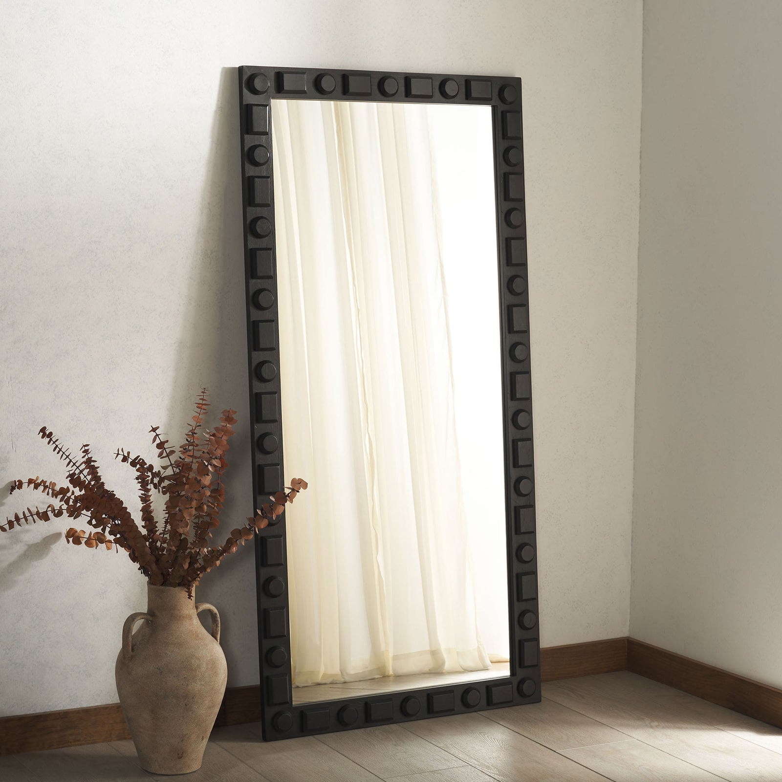 Tall mirror with a bold black geometric frame brings graphic contrast to a neutral space || MRR9022A || front_angle_room