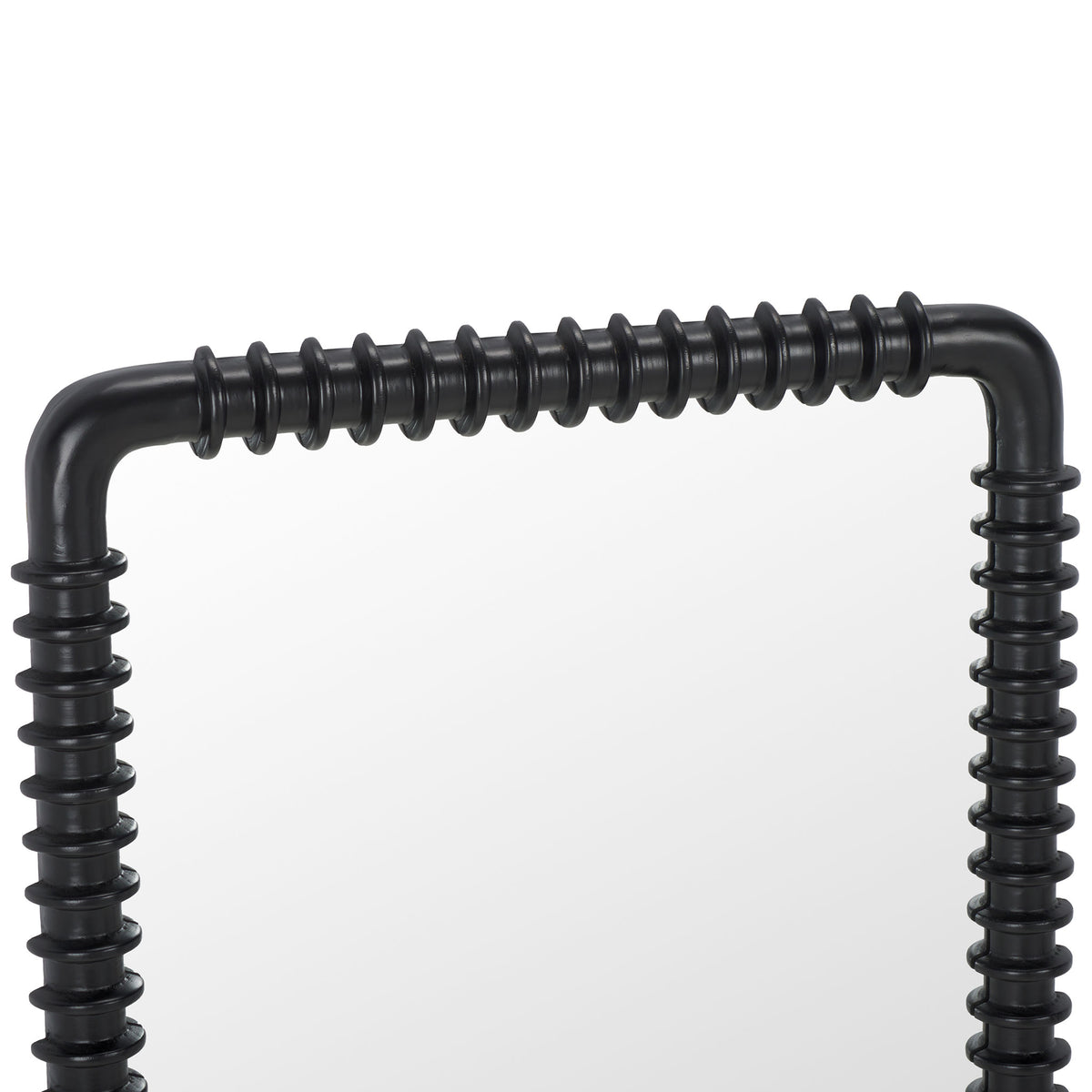 Repeating rings line the black frame of a tall mirror with softly rounded corners.