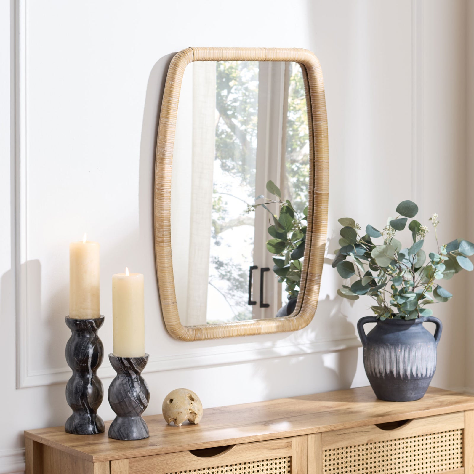 Natural rattan framing adds soft curves and organic texture above a wood console || MRR9032A || front_room