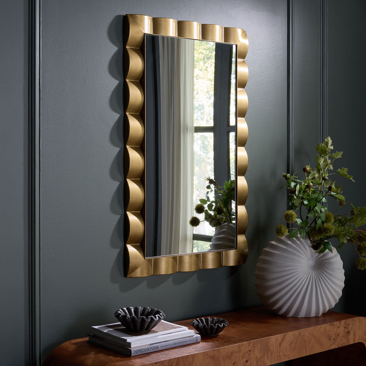 A scalloped gold frame brings a warm, sculptural accent to a dark wall || MRR9035A || front_angle_room