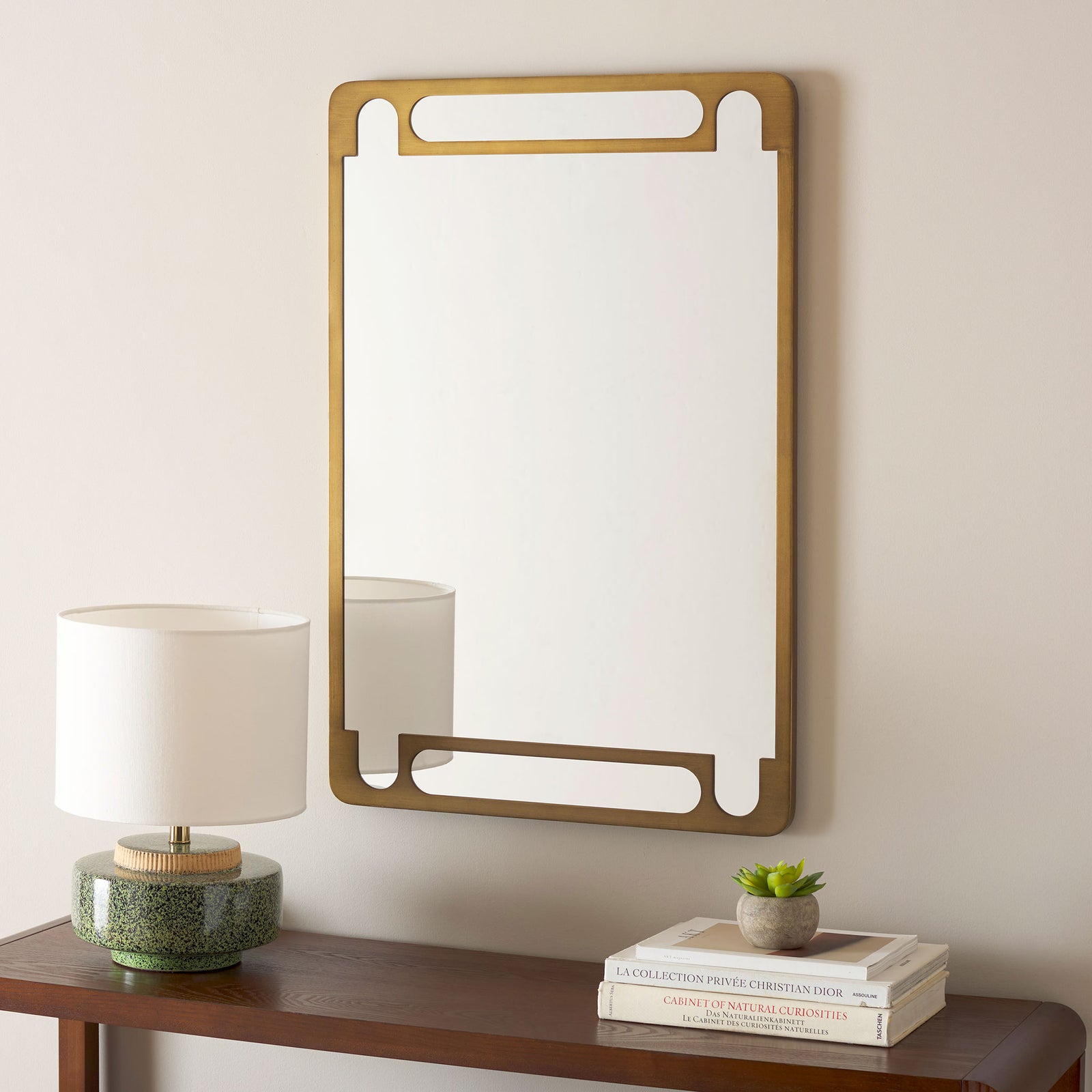 An antique gold mirror adds warm, geometric charm above a dark wood console || MRR9038A || front_room