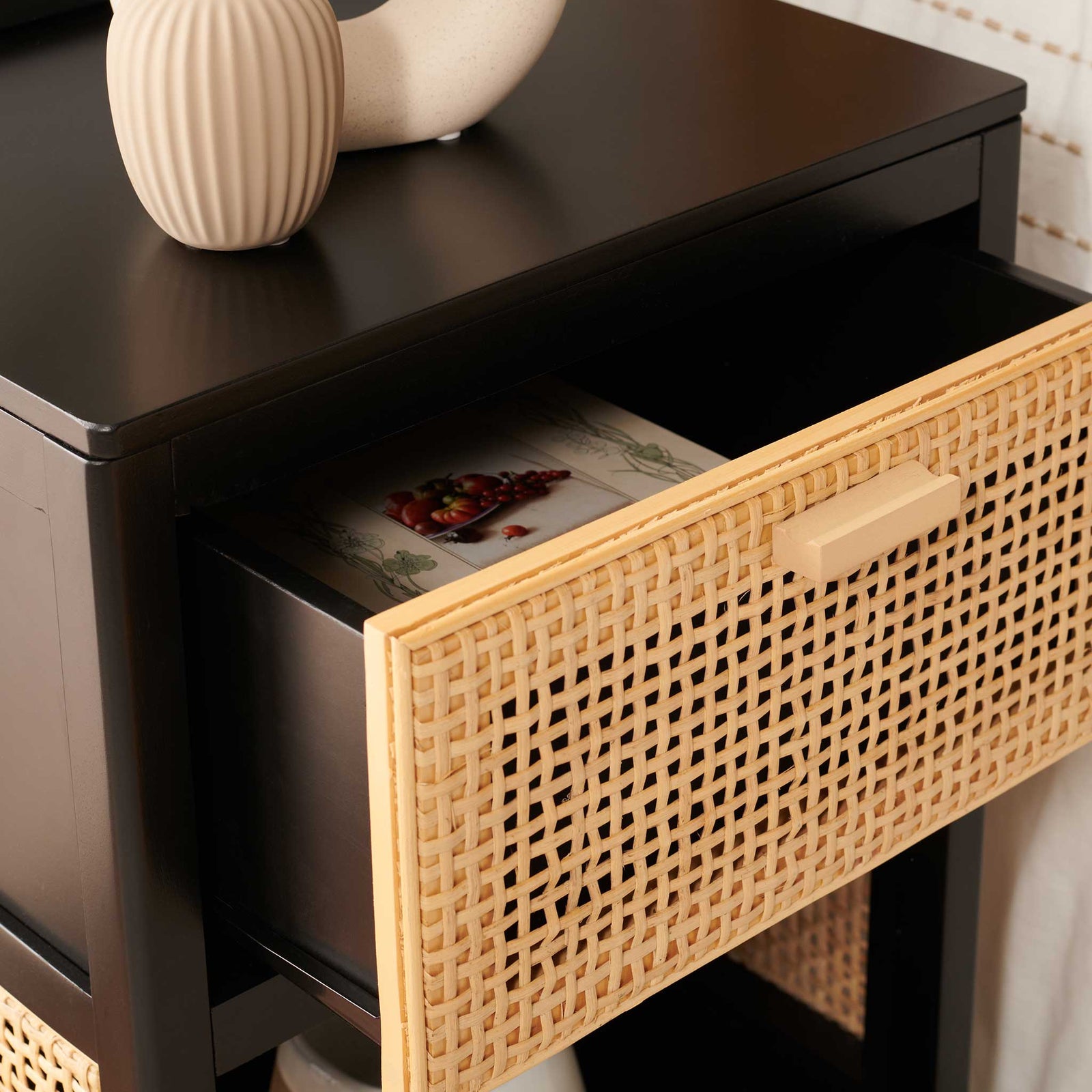 Woven cane drawer with wood pull opens to reveal a roomy interior for nighttime essentials. || NST5012B || storage_open_room