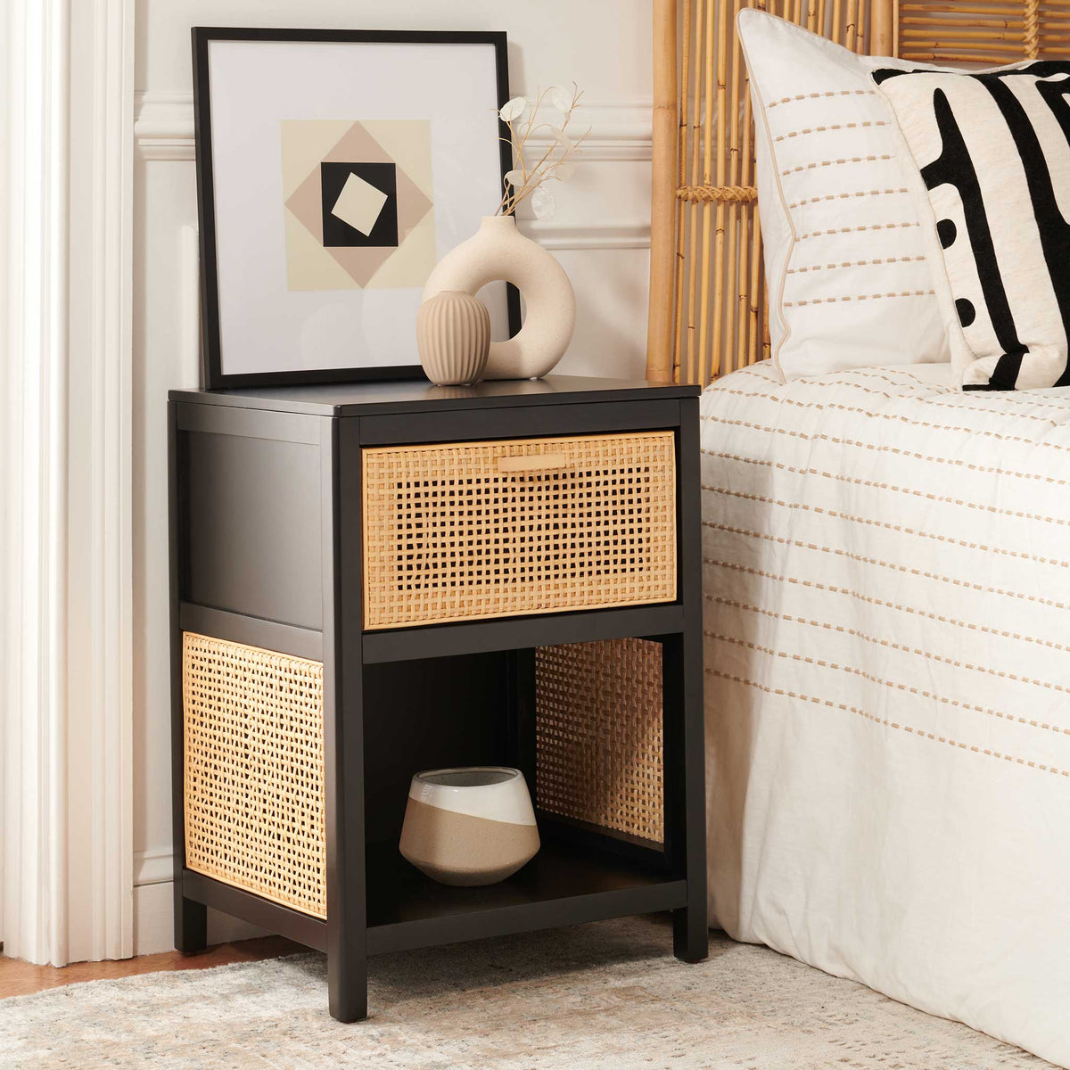 Cane-front nightstand warms the bedside with a black frame and open shelf for essentials. || NST5012B || front_angle_room