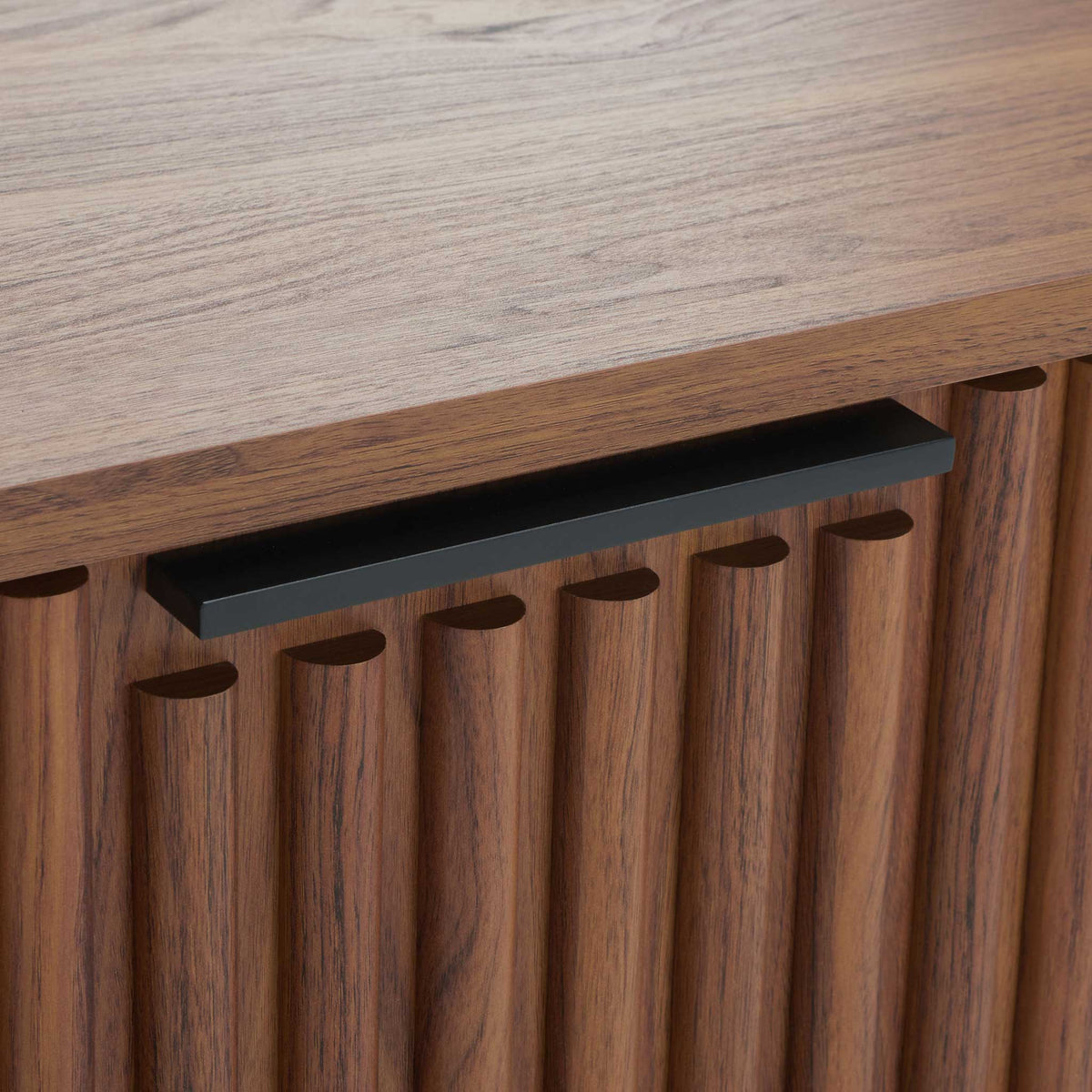 Sleek black pull handle complements the fluted walnut drawer front || NST9605A || handle_studio