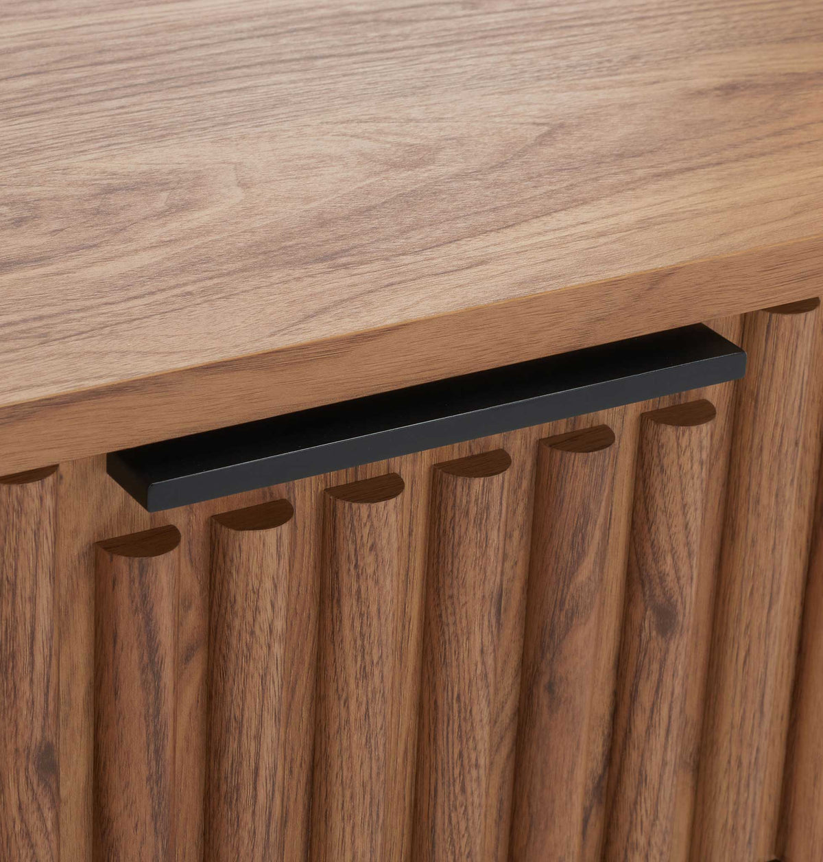 Low-profile matte black bar pulls complement the warm oak grain || NST9605D || handle_studio