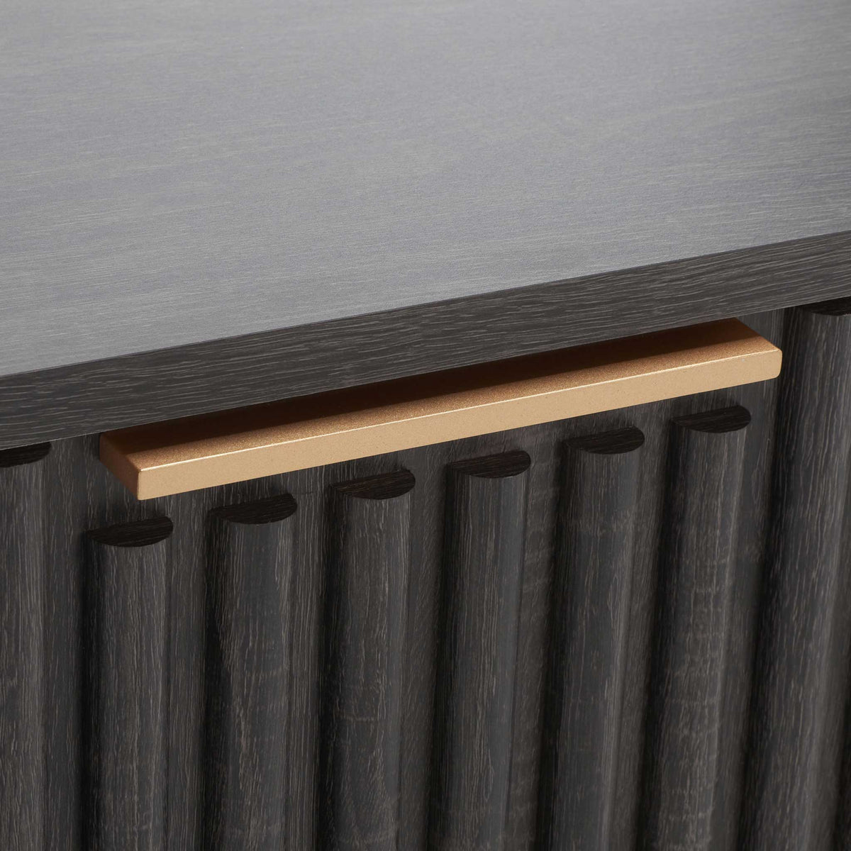 Linear gold pull adds a modern accent against the fluted drawer front || NST9605E || handle_studio