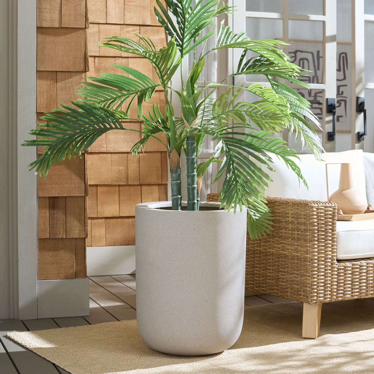 Tall beige planter brings warm, understated texture to a leafy palm arrangement || PAT1400B || front_room