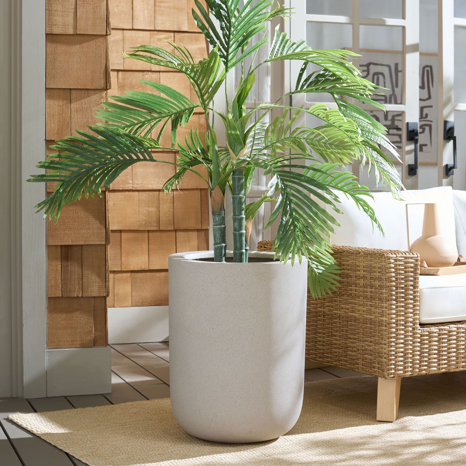 Tall beige planter brings warm, understated texture to a leafy palm arrangement || PAT1400B || front_room