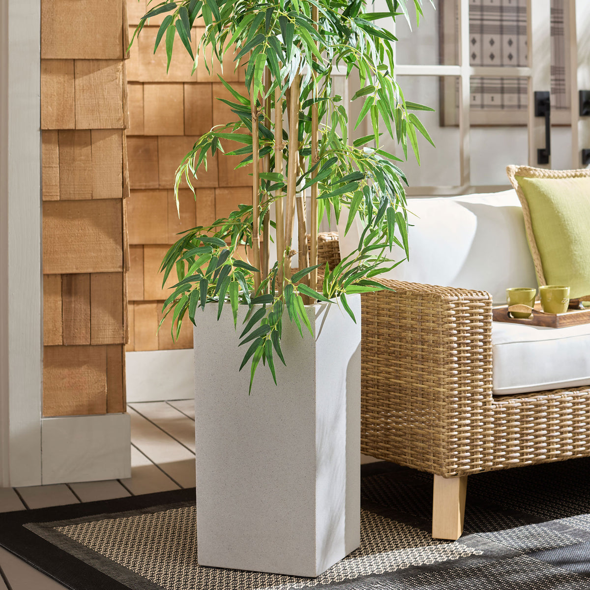 Tall beige square planter brings lush greenery to a relaxed patio seating area || PAT1402B || front_angle_room
