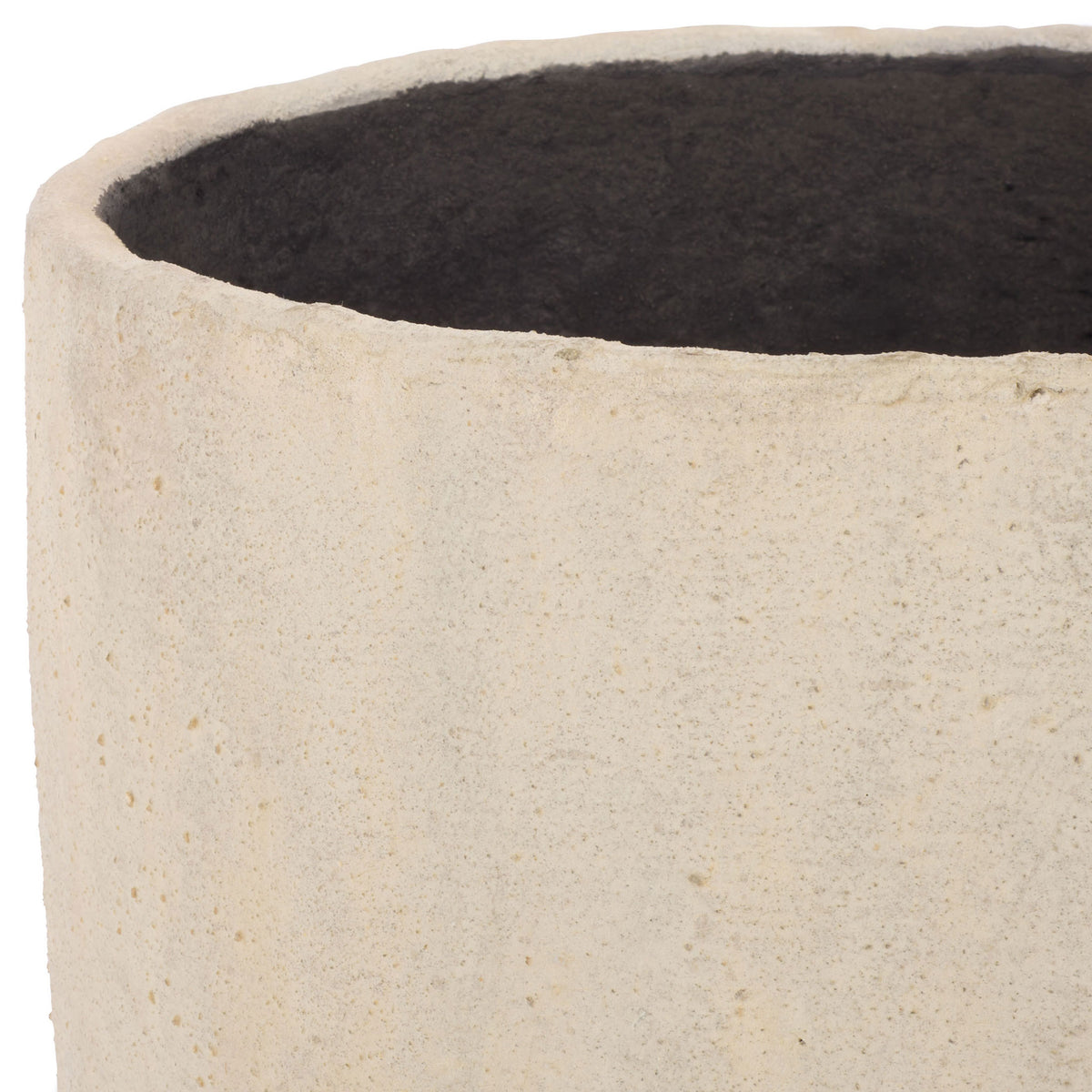 An uneven beige rim frames the planter's dark interior and softly textured surface.
