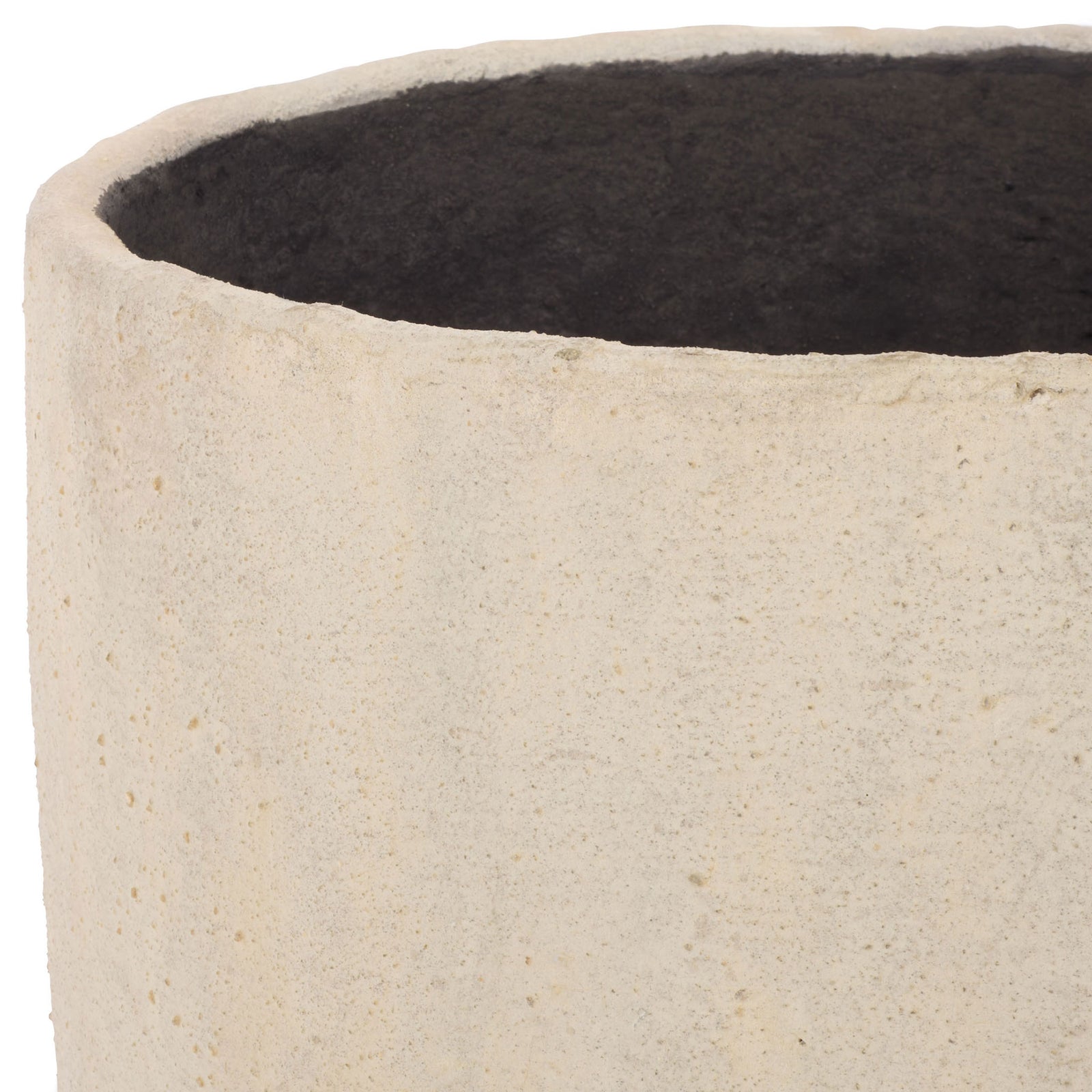 An uneven beige rim frames the planter's dark interior and softly textured surface. || PAT1404B || detail_studio
