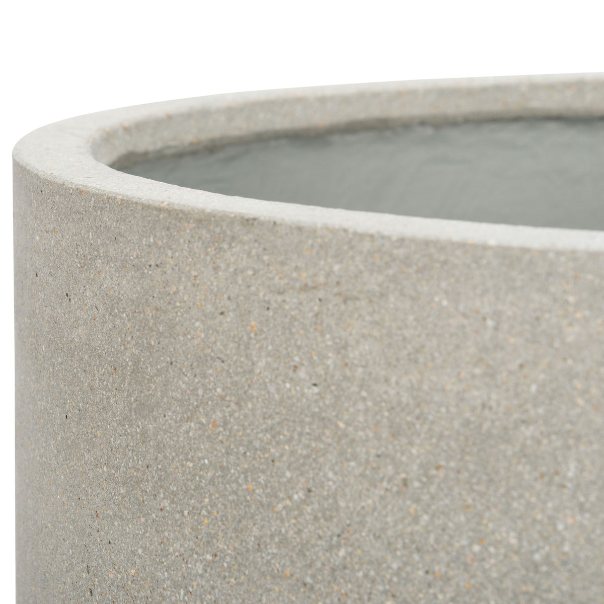A softly rounded rim reveals the fine flecks and stone-like texture of the light gray pot.