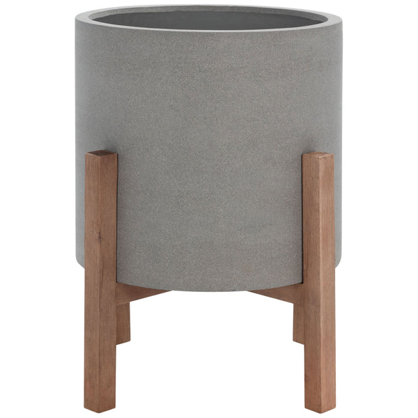A generous gray cylindrical planter rests on a warm wood-toned stand. || PAT1515B || front_studio