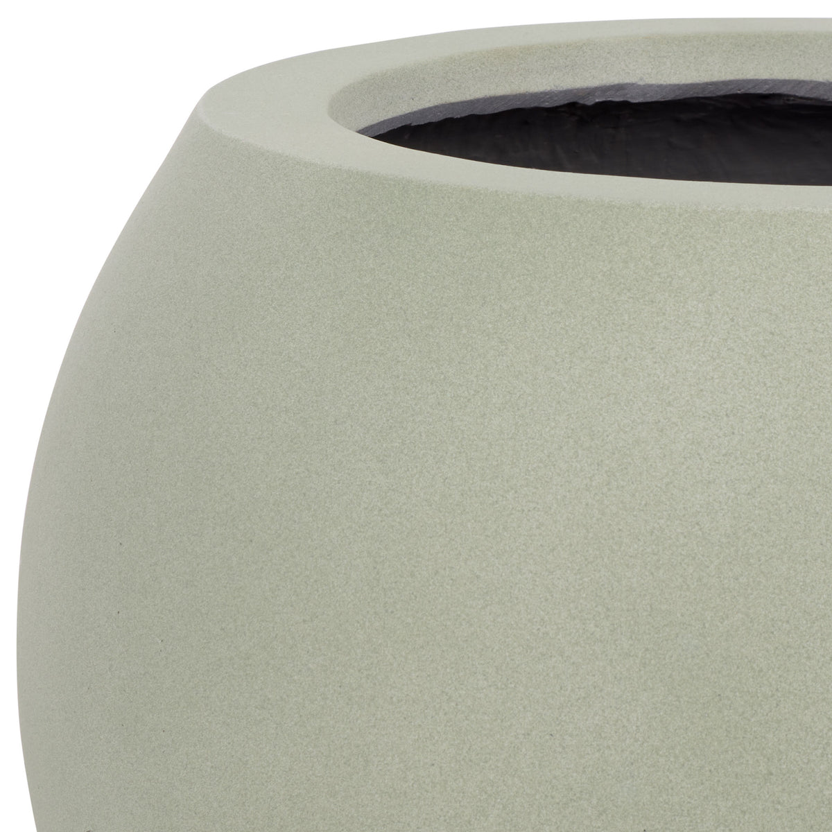 A wide sage rim borders the dark planting interior above a finely textured curved wall.