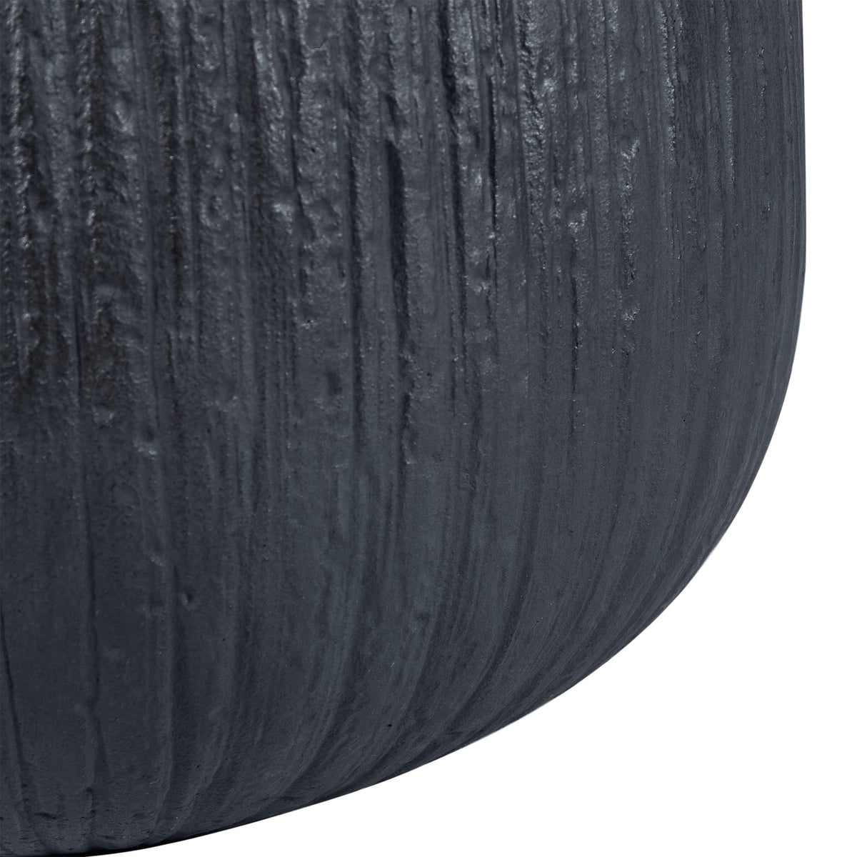 Bark-like grooves run down the black planter's softly curved base