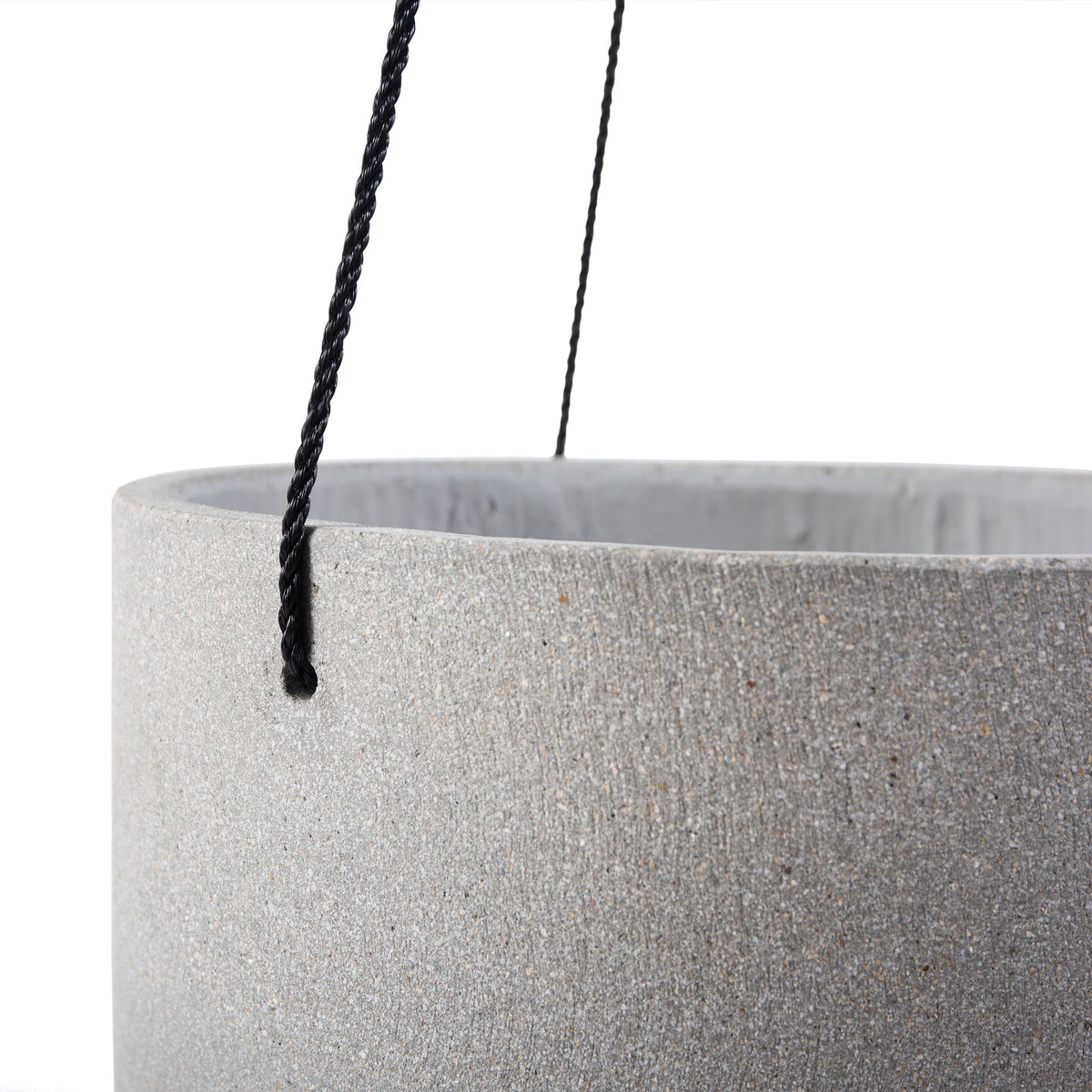 A dark braided cord passes through the rim of a grainy light gray planter. || PAT1527B || detail_studio