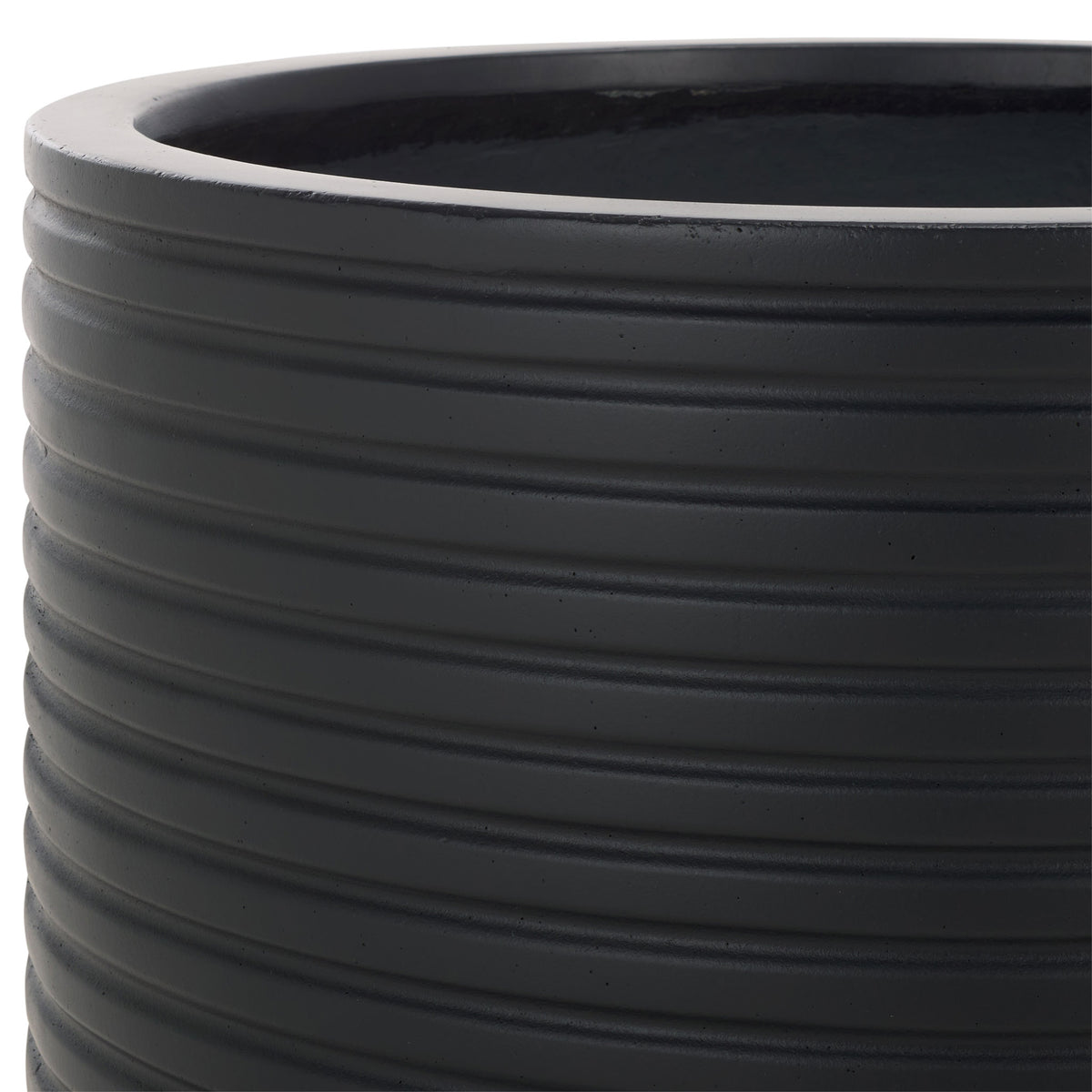 A bold black rim and tightly spaced horizontal grooves give the planter a clean, modern finish