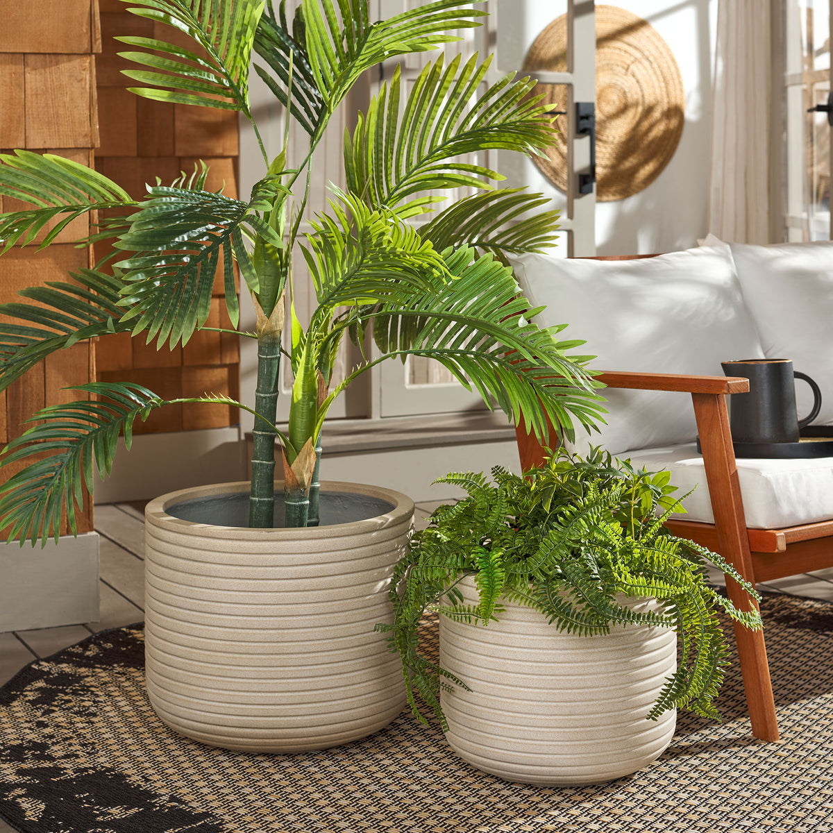 Two beige ribbed planters bring lush palms and ferns to a cozy seating space || PAT1530B-SET2 || front_angle_room