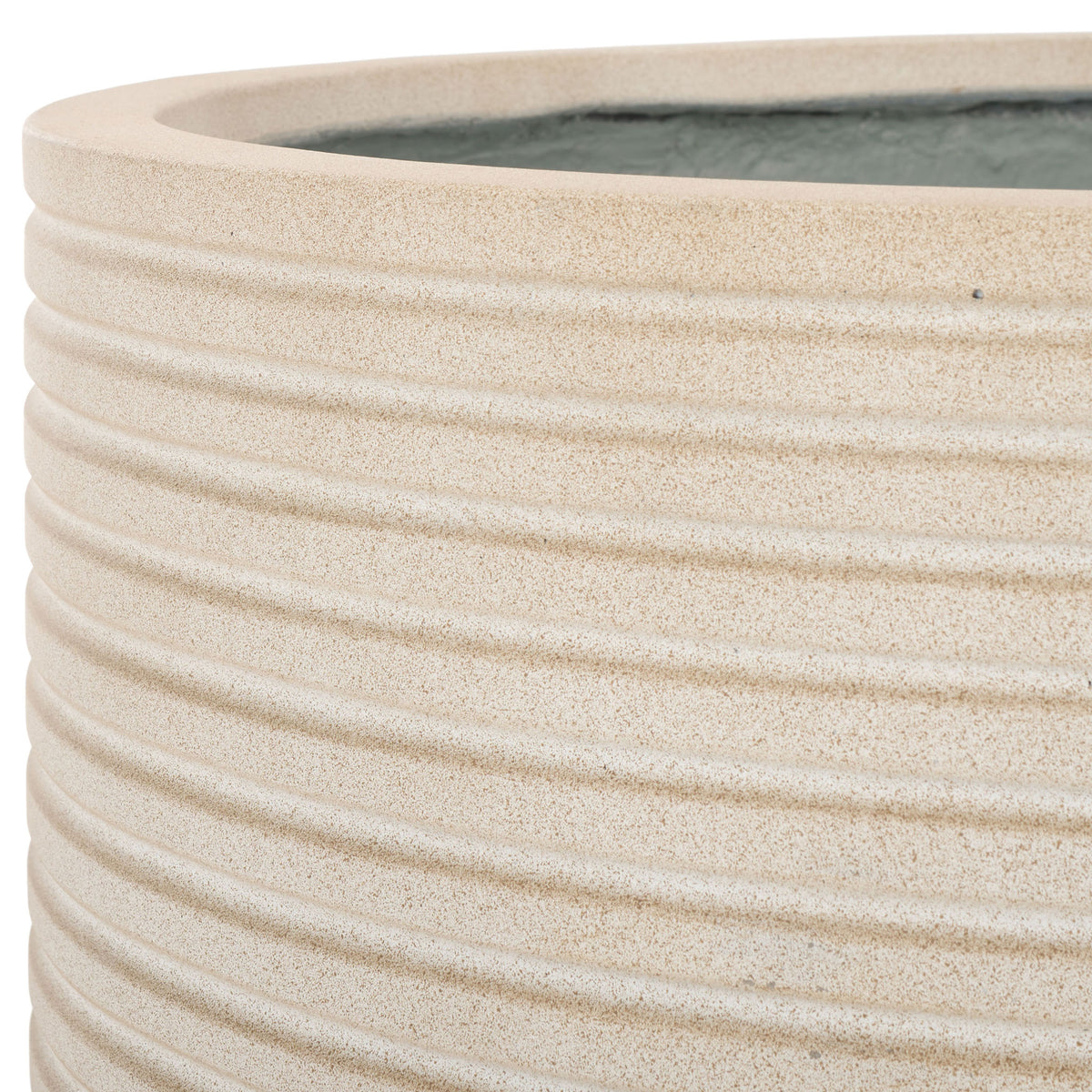 A generous beige rim and fine, stacked ribs bring soft texture to the planter's rounded form