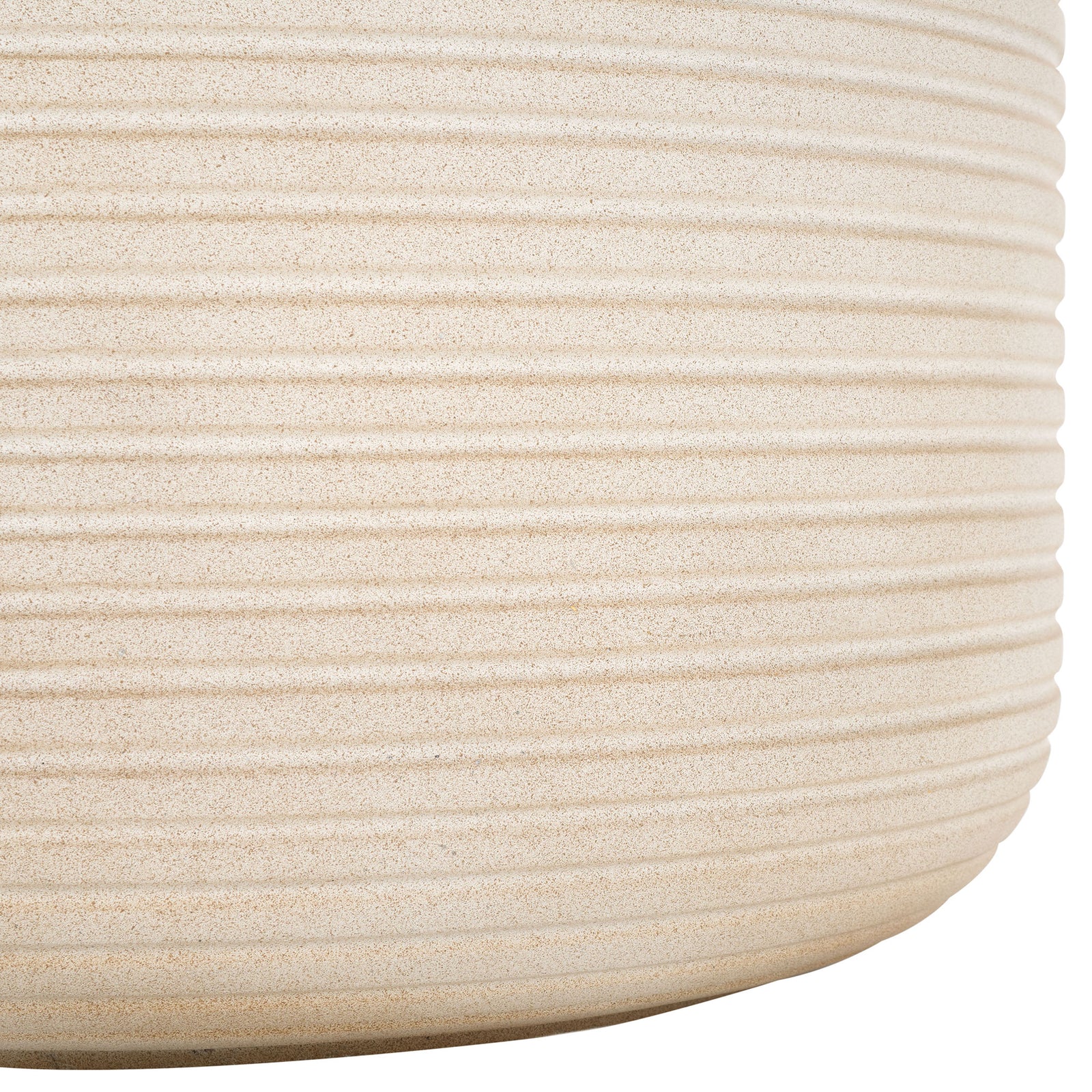 The beige planter's softly rounded base shows off its sandy finish and closely spaced ribs || PAT1531B || leg_studio