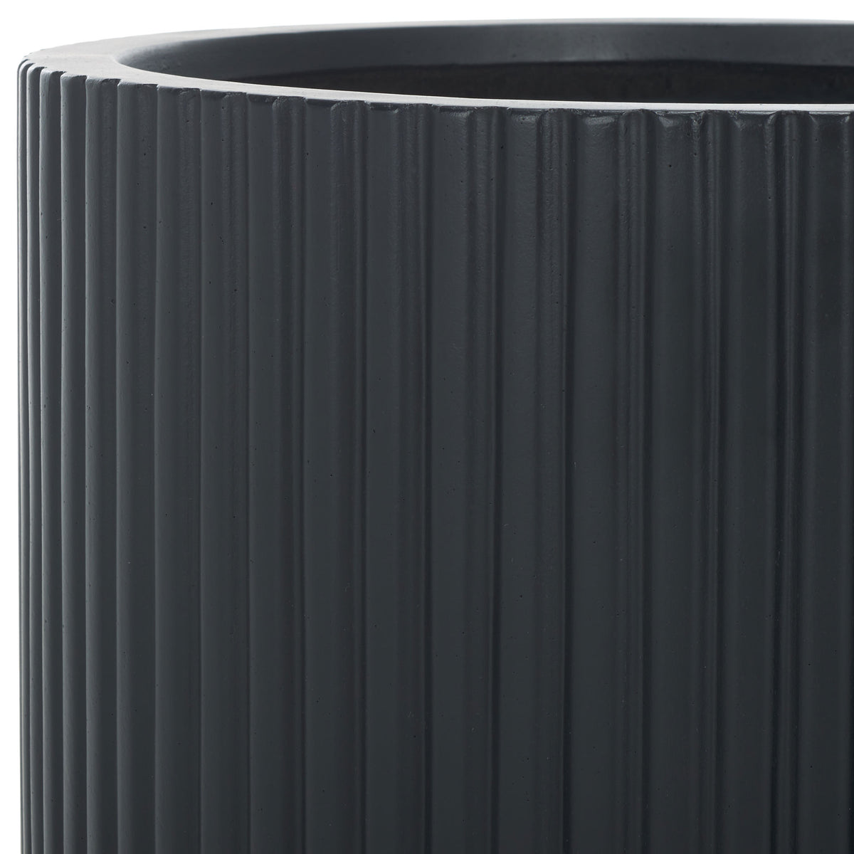 A bold black rim frames the deep opening above closely set, sculptural vertical ribs.